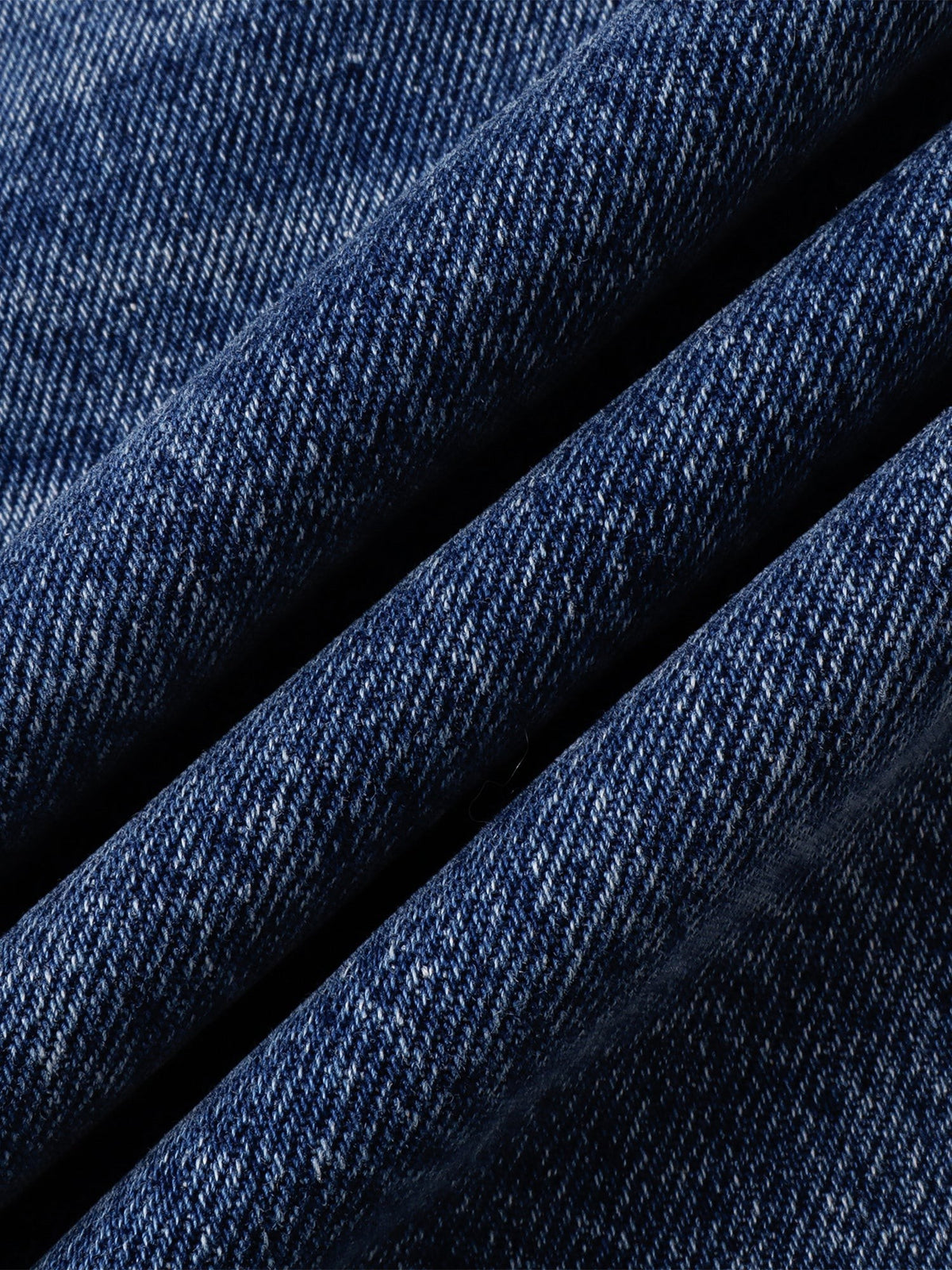 Close-up of the deep blue denim weave and tonal wash