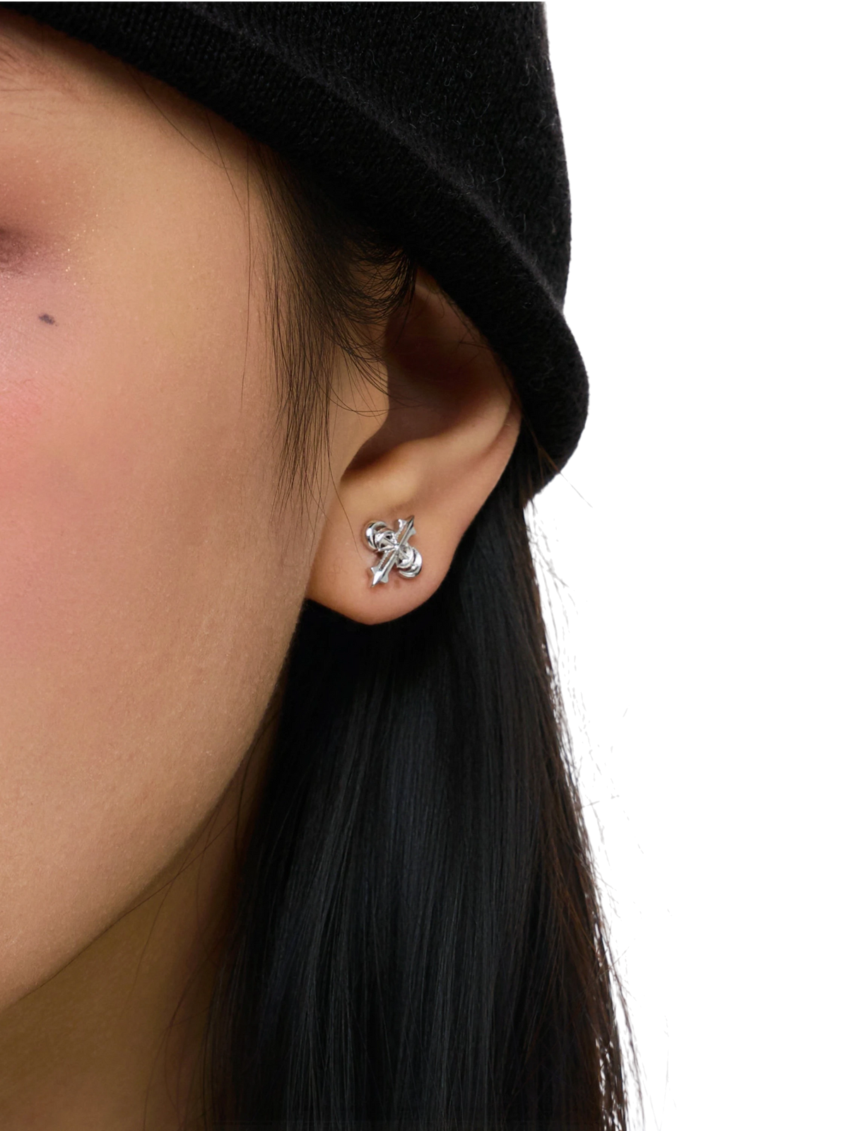 Close-up of the sculpted TBHNP logo earring