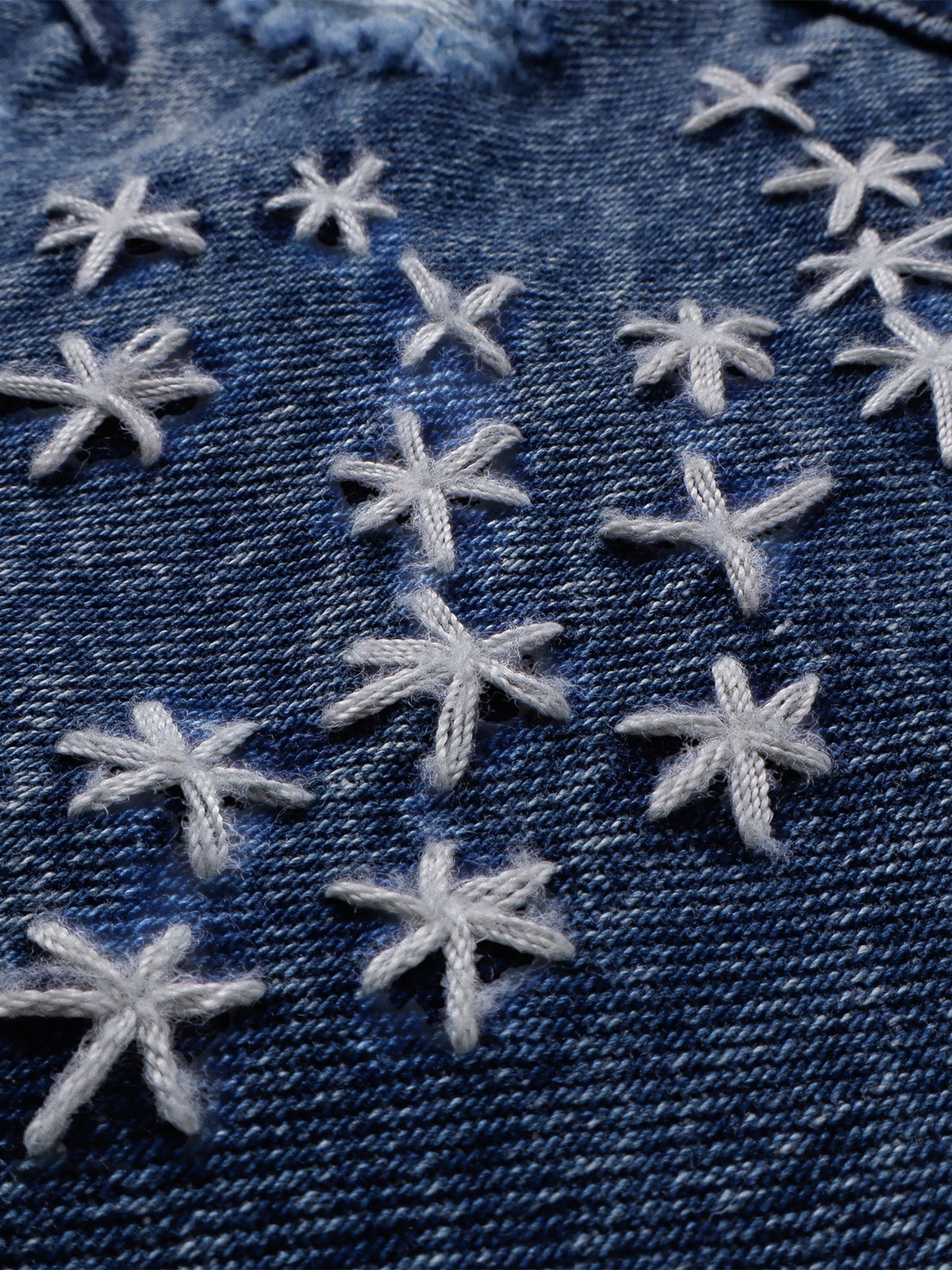 Hand-stitched cross motifs on Luminous Dawn blue washed denim