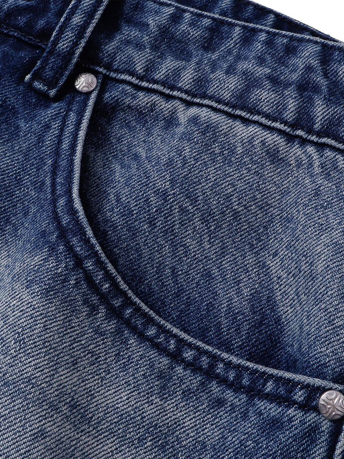 Close-up of the front waist, coin pocket and faded denim wash