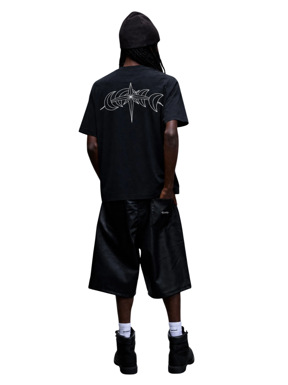 Model wearing the black Luminous Dawn T-shirt with an astral star and crescent back graphic