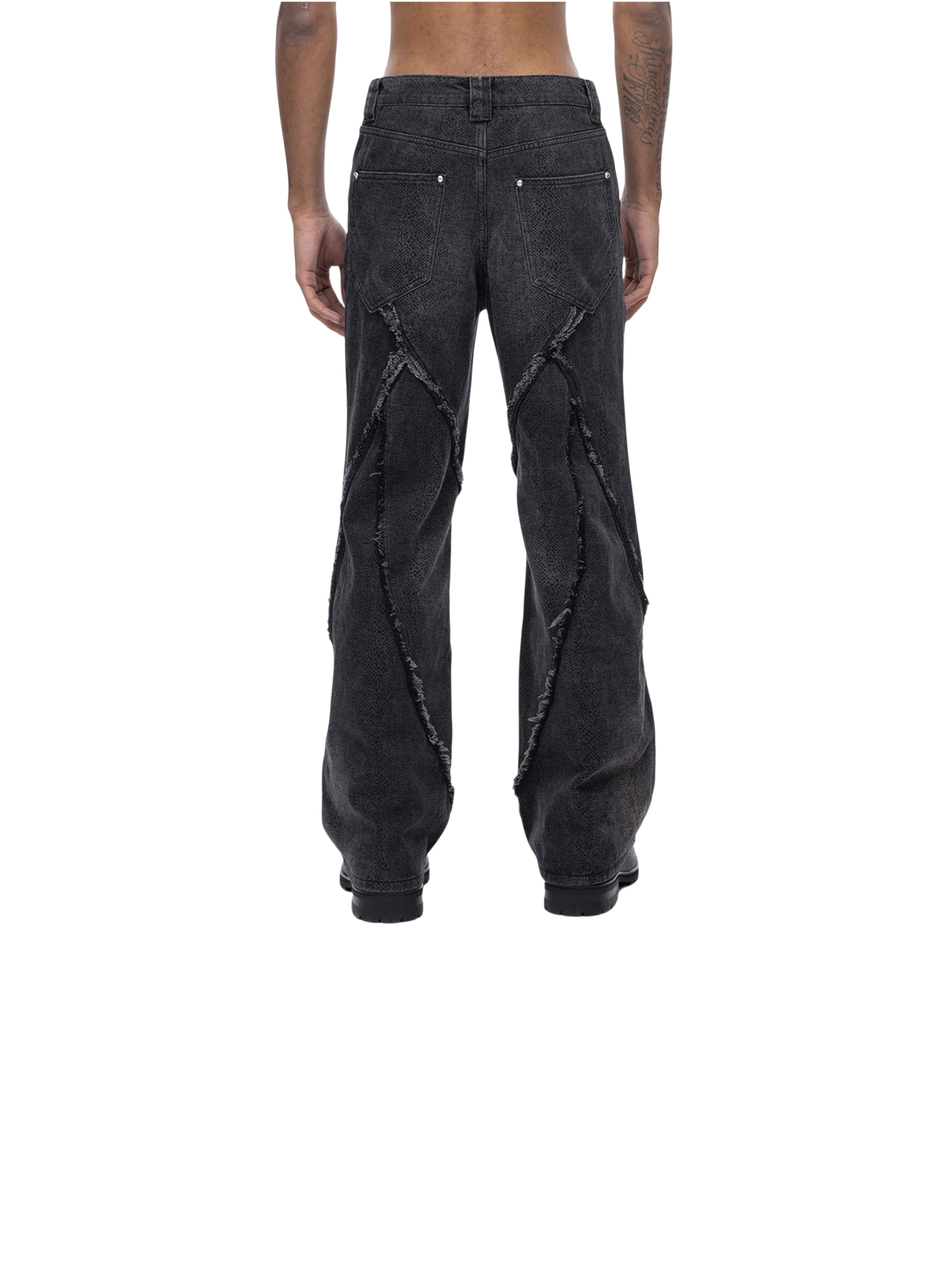 Model in TBHNP cobra print baggy jeans, front detail — men's streetwear denim