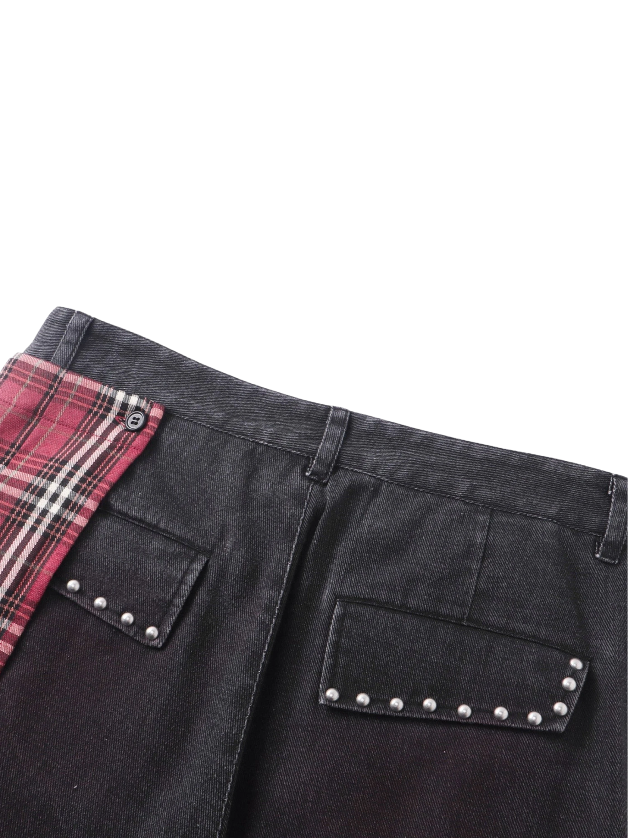 Close-up of the back pocket studs and plaid trim on TBHNP skirt trousers — men's streetwear detail