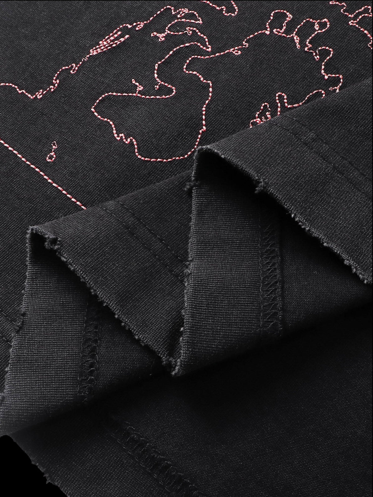 Close-up of the back graphic print on TBHNP black arrival short-sleeve tee — men's streetwear detail