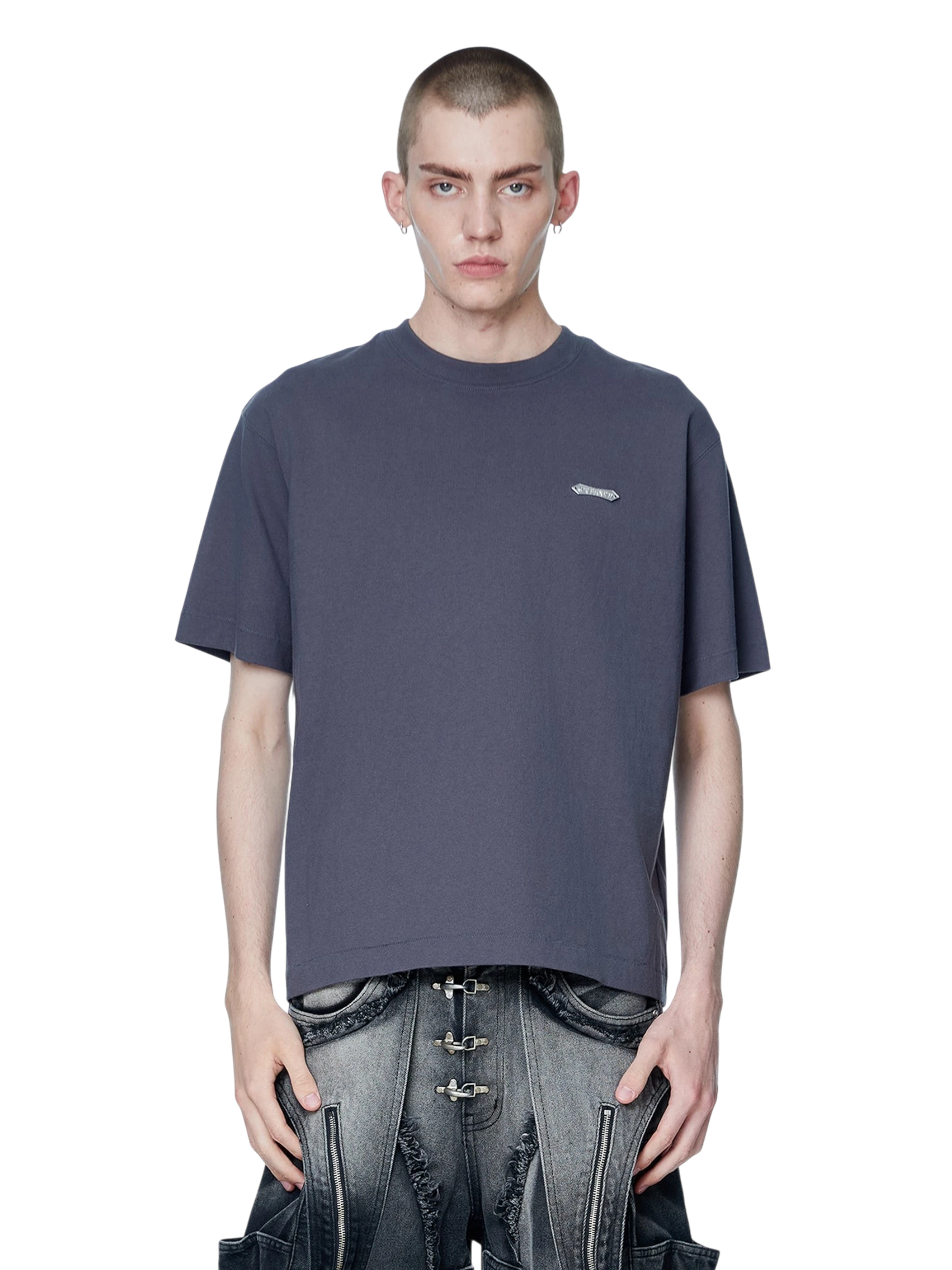 Model wearing TBHNP dark grey Emblem & Shadowbat tee, front — men's streetwear tee
