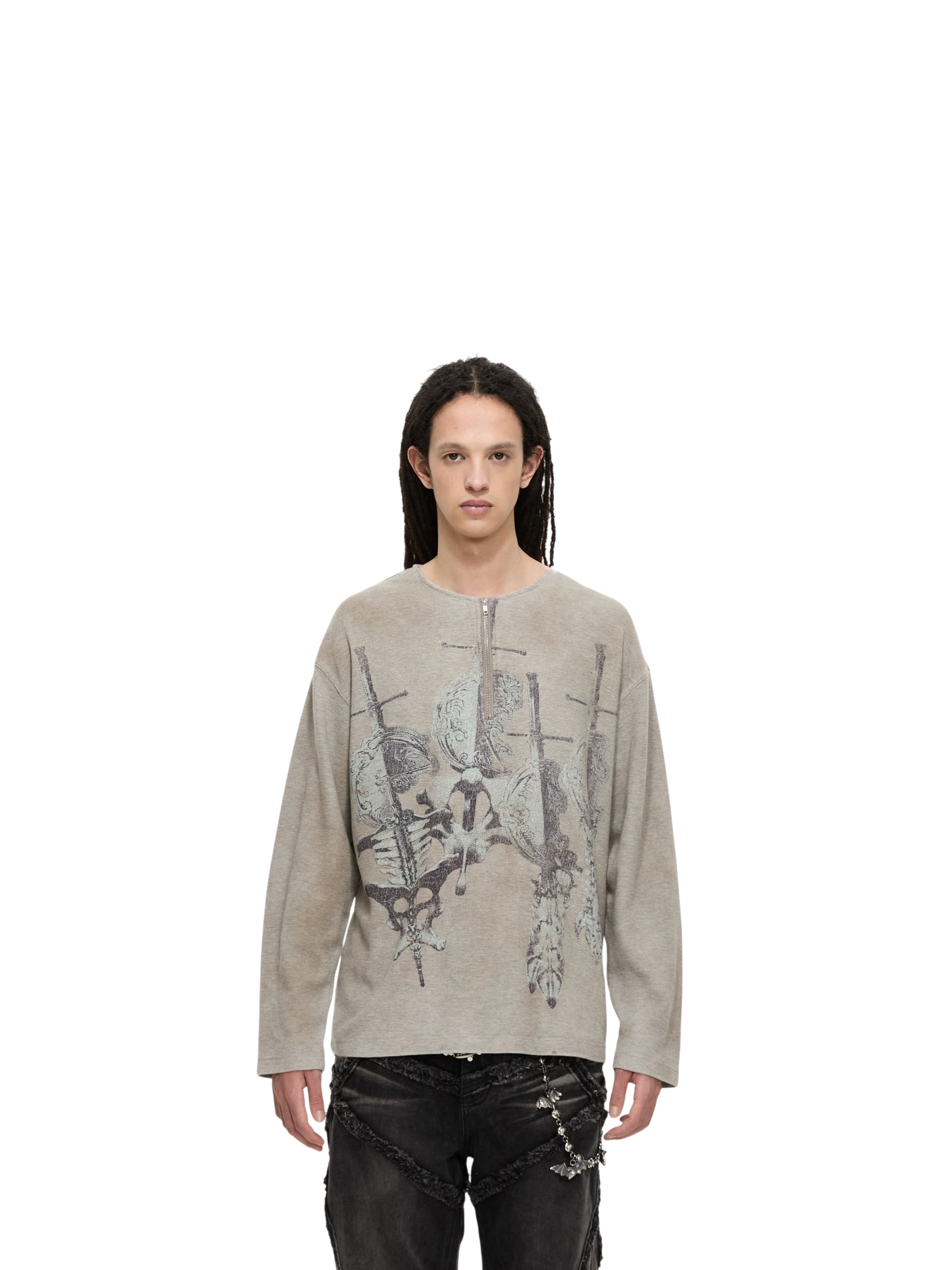 Model wearing TBHNP grey waffle henley long-sleeve tee with sword-and-bone print, front — men's streetwear