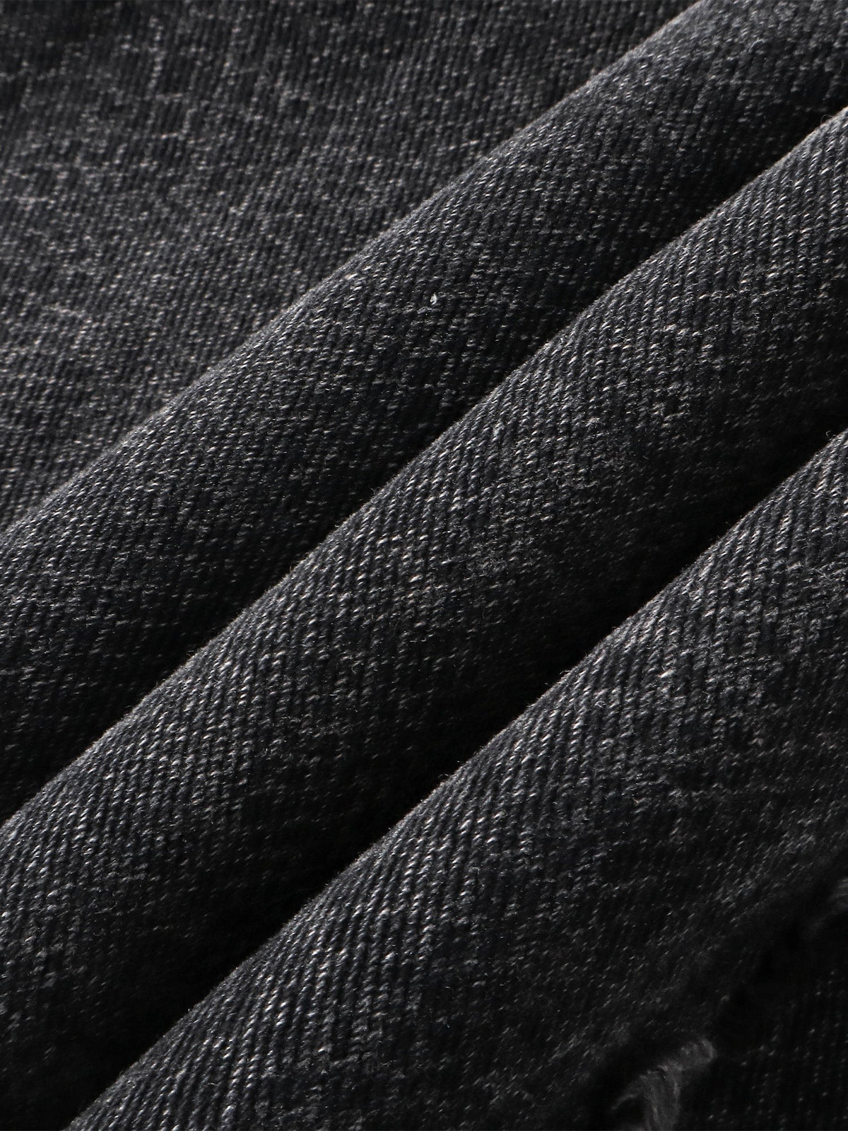 Close-up of the 3D snake-curve panel seam on TBHNP cobra print jeans — men's streetwear detail