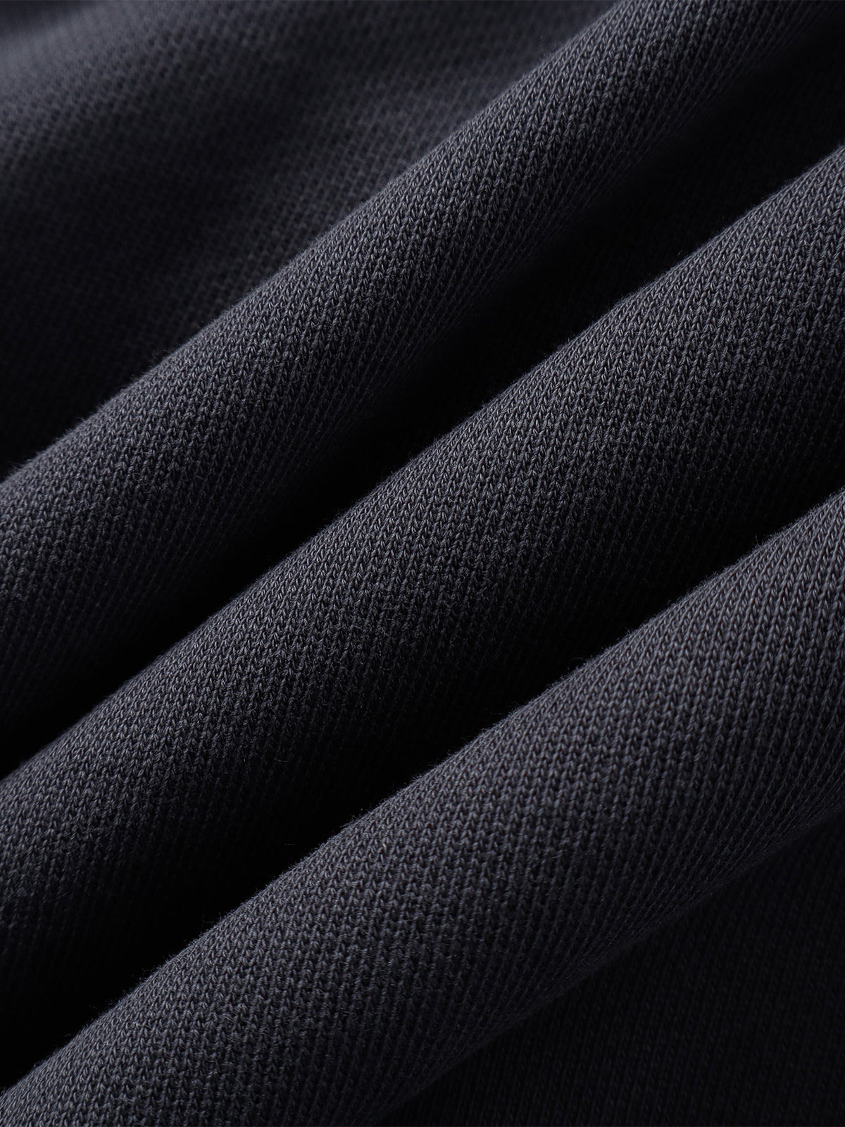 Close-up of the Black hoodie hem and seam finish.