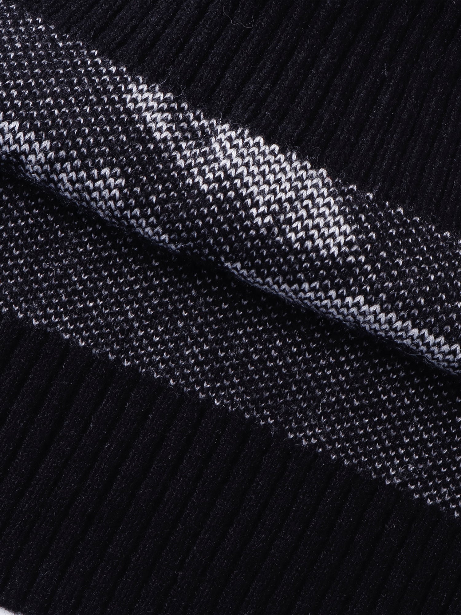 Close-up of the sweater vest armhole and jacquard construction.