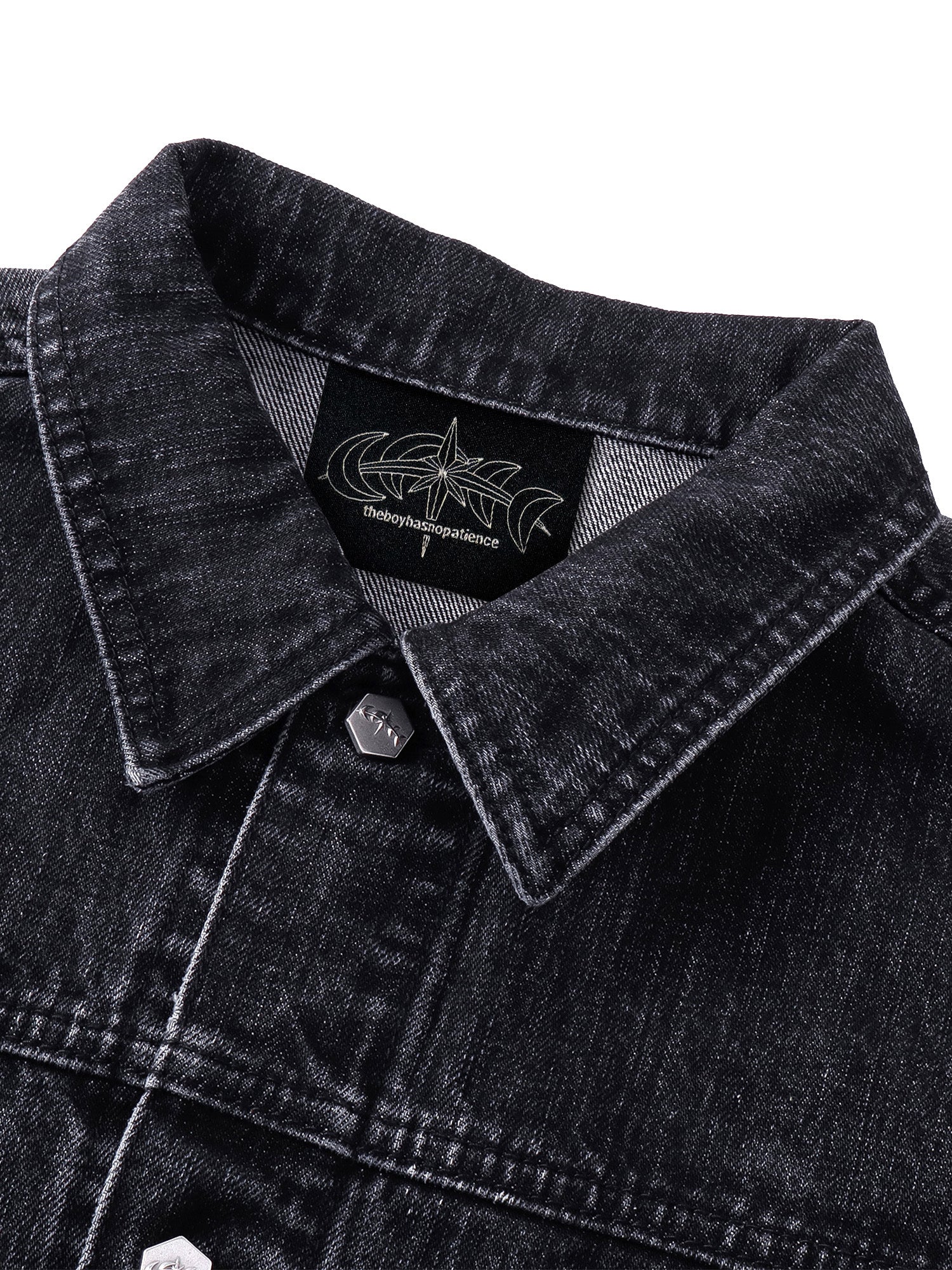 TBHNP T260016 black denim jacket, collar, logo label, and metal button detail.