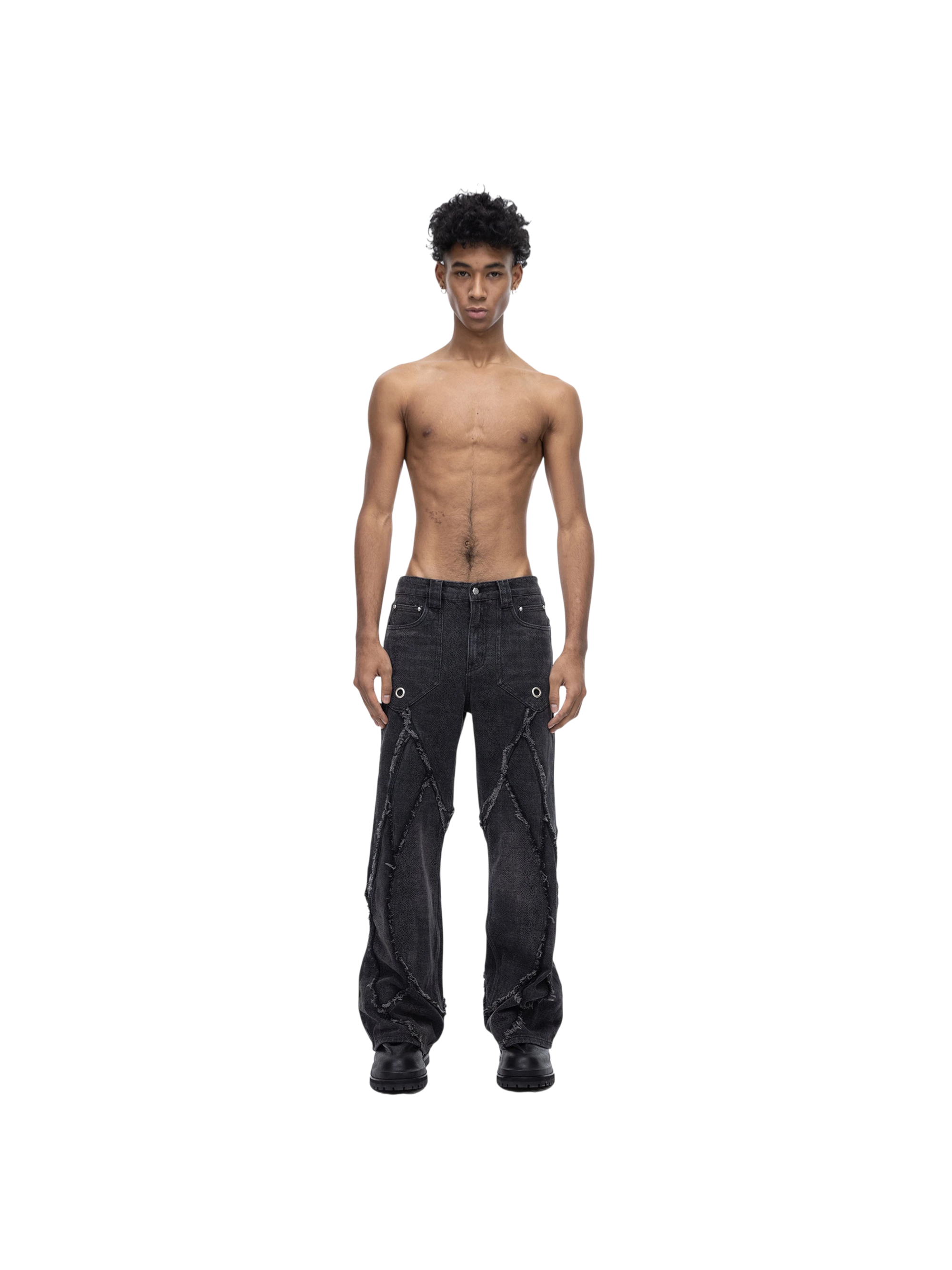 Male model wearing TBHNP black baggy jeans, side-back view — men's streetwear denim