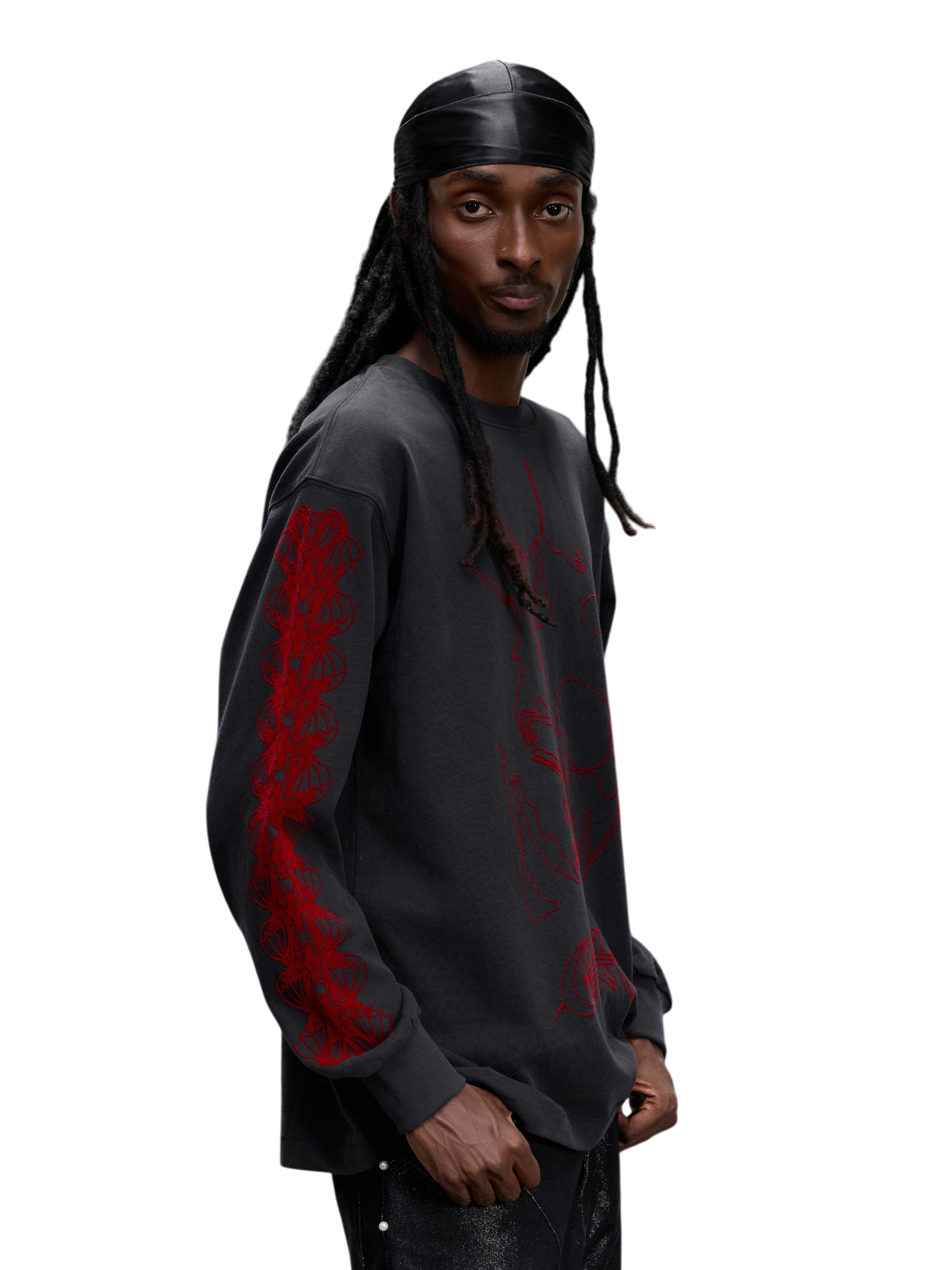 Model wearing Dark Grey flocked long-sleeve tee, three-quarter view