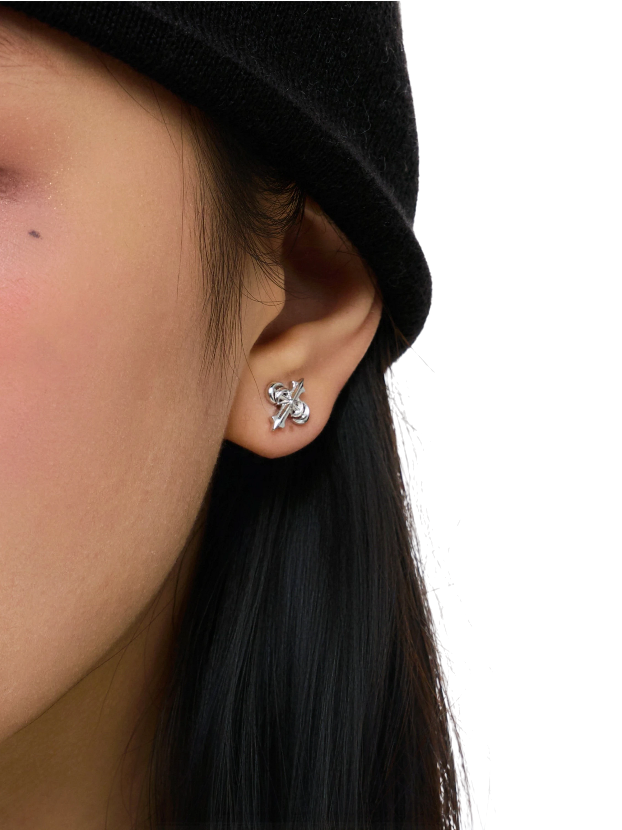 Close-up of the sculpted TBHNP logo earring