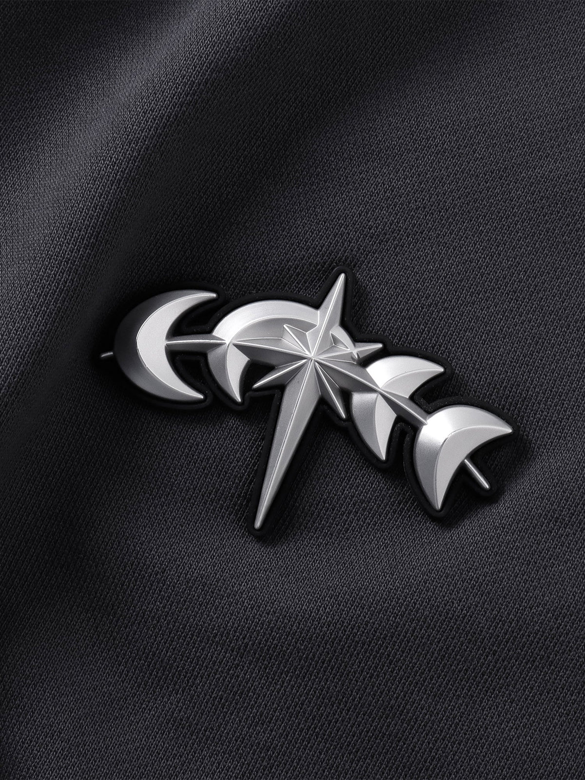 Close-up of the Black pants side patch and metal hardware.