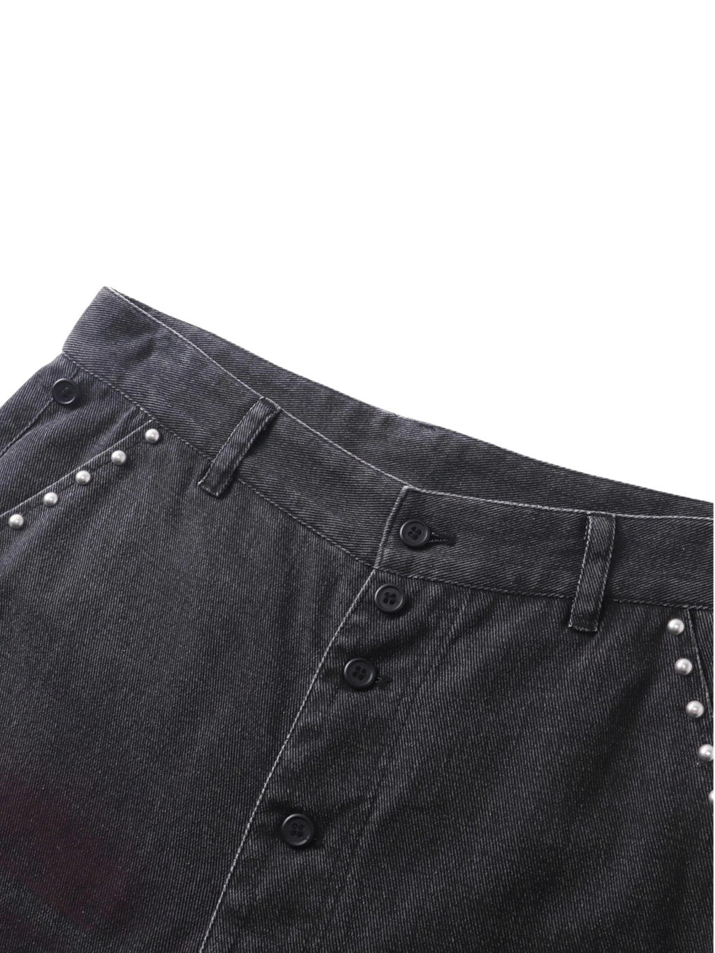 Close-up of the studded back pockets on TBHNP black spray-washed trousers — men's streetwear detail