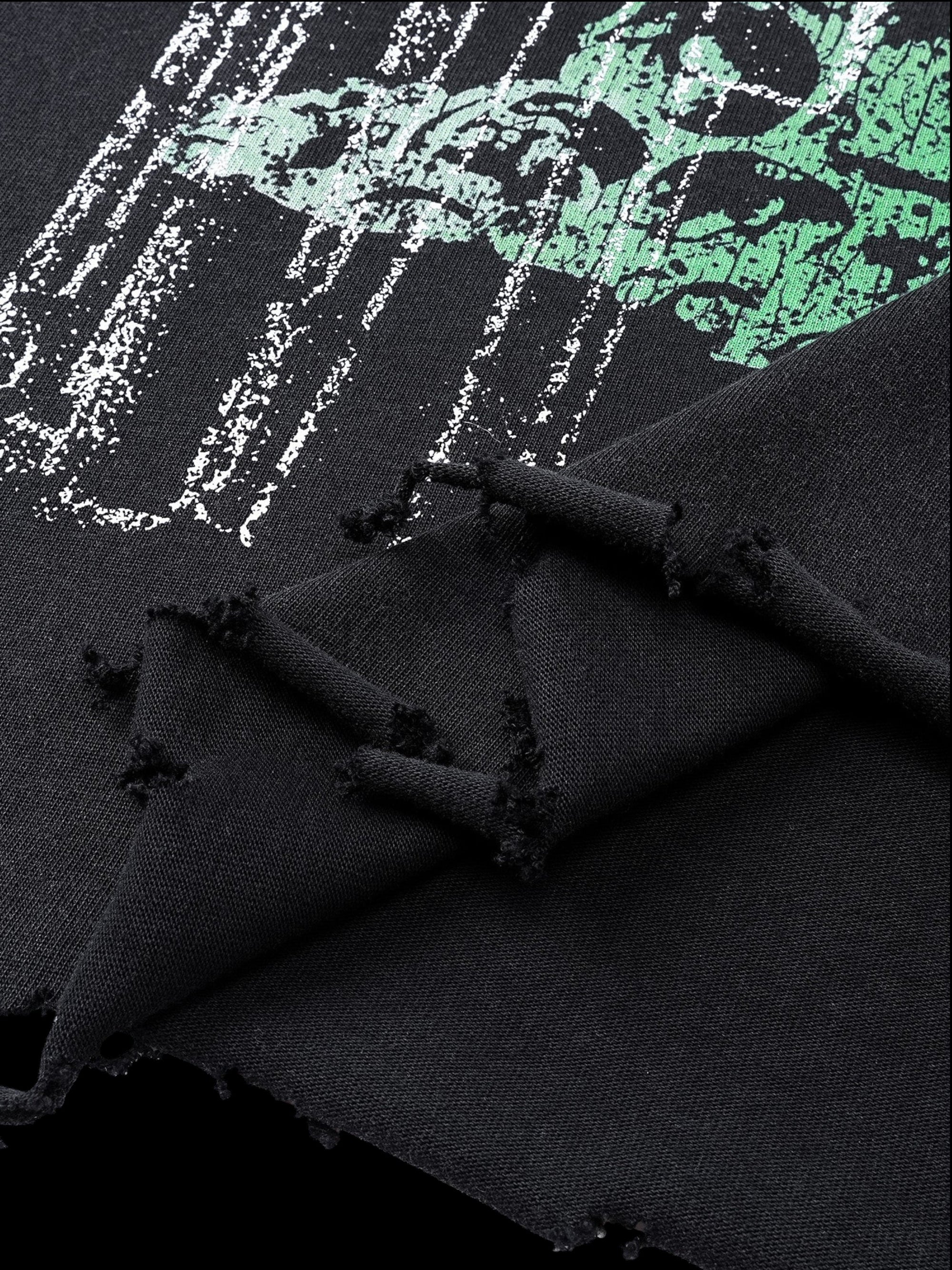 Close-up of the green print and destroyed holes on TBHNP black tee — men's streetwear detail