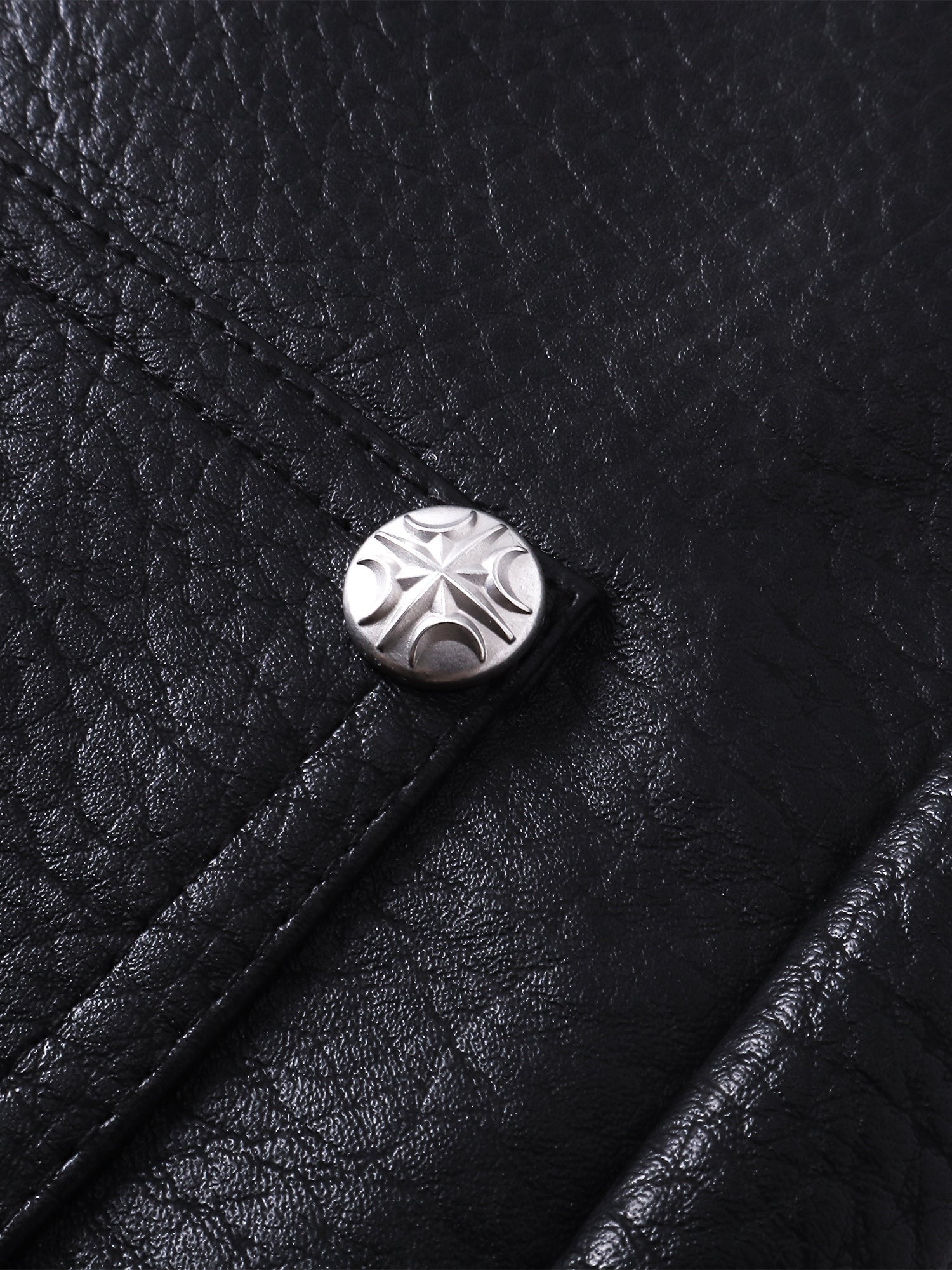 Close-up of the metal button on TBHNP black faux-leather shorts — men's streetwear detail