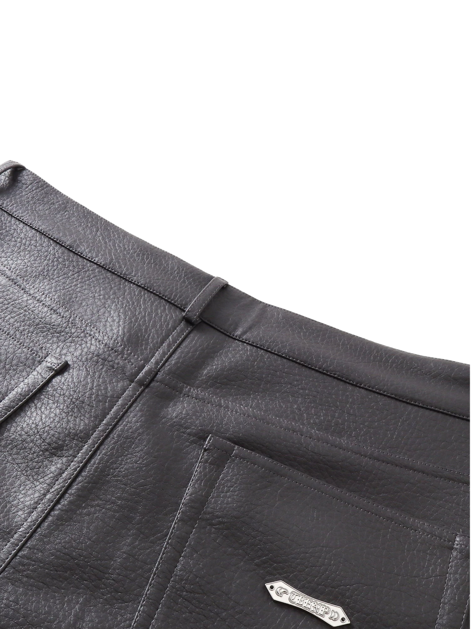 Close-up of the front pocket on TBHNP black faux-leather shorts — men's streetwear detail