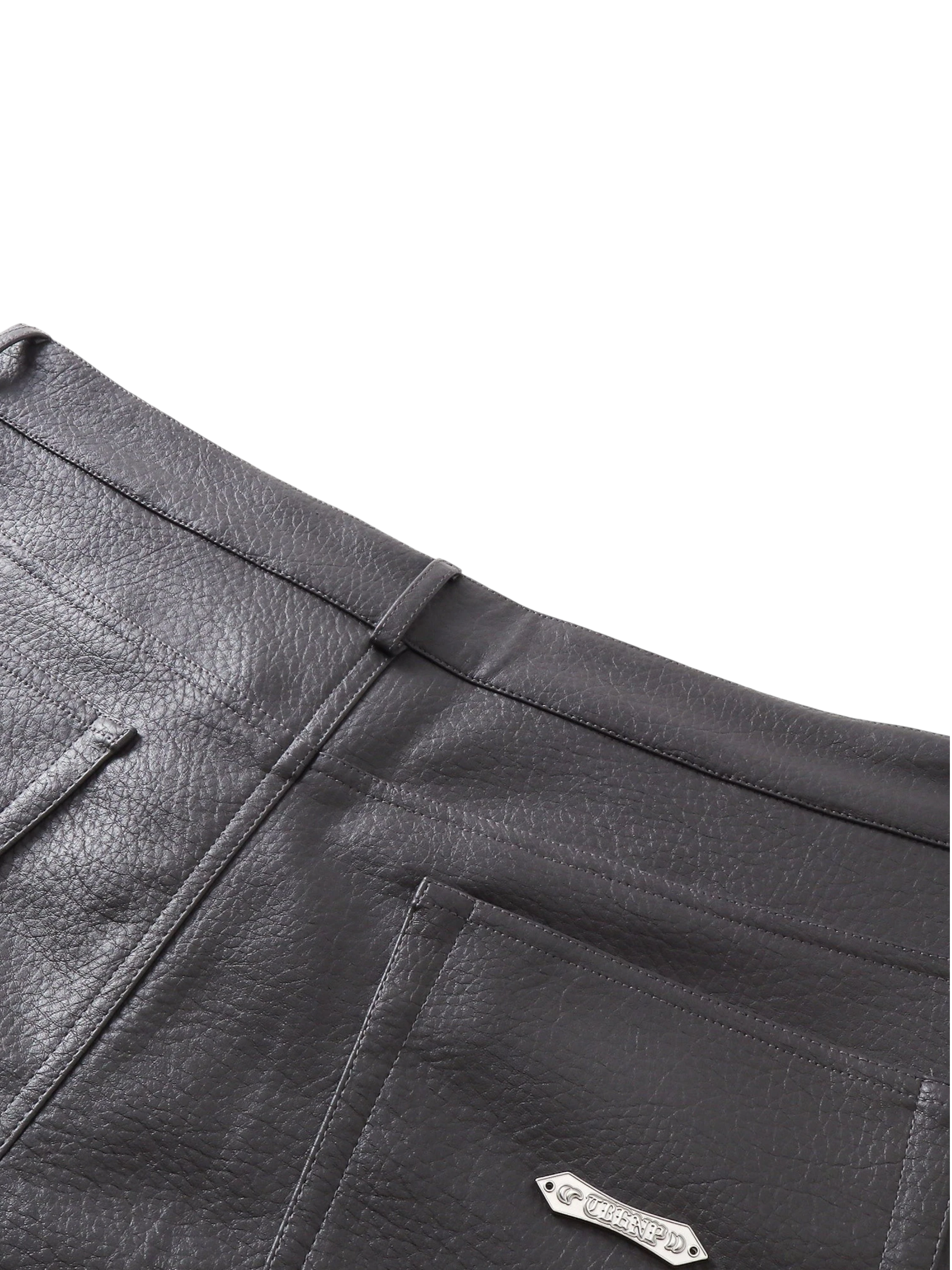 Close-up of the front pocket on TBHNP black faux-leather shorts — men's streetwear detail