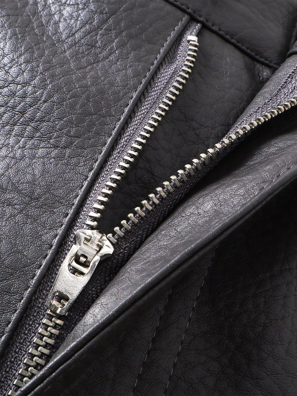 Close-up of the zip fly on TBHNP black faux-leather shorts — men's streetwear detail