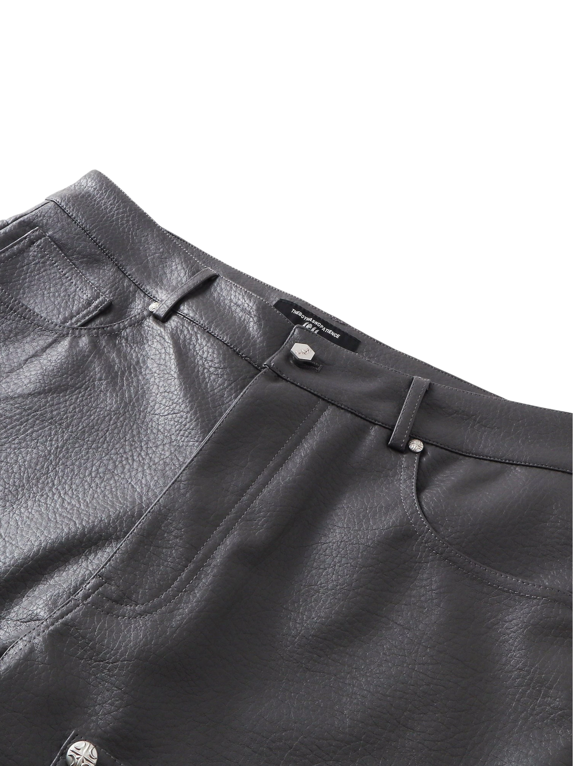 Close-up of the high waistband and pockets on TBHNP faux-leather shorts — men's streetwear detail