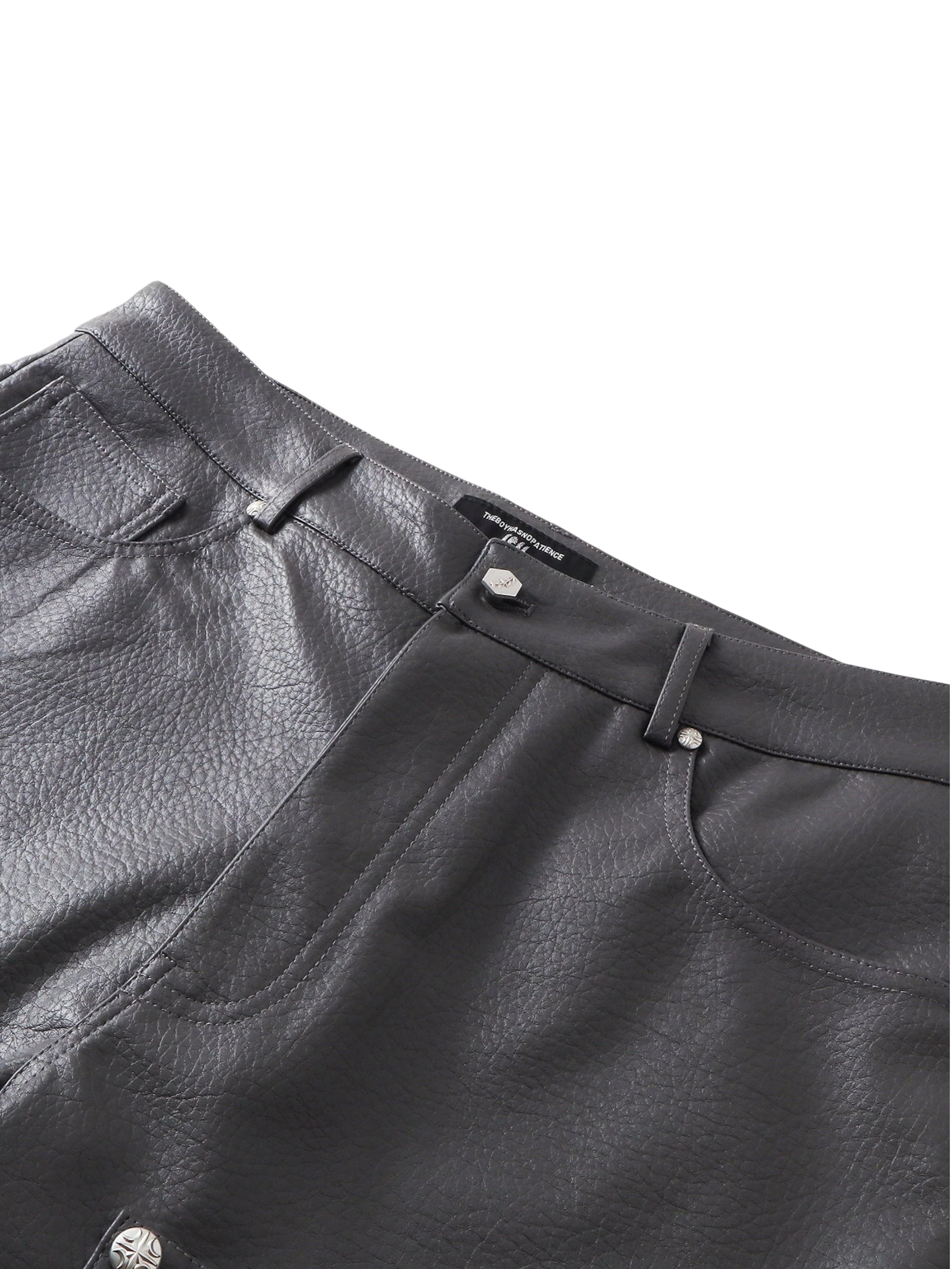 Close-up of the high waistband and pockets on TBHNP faux-leather shorts — men's streetwear detail