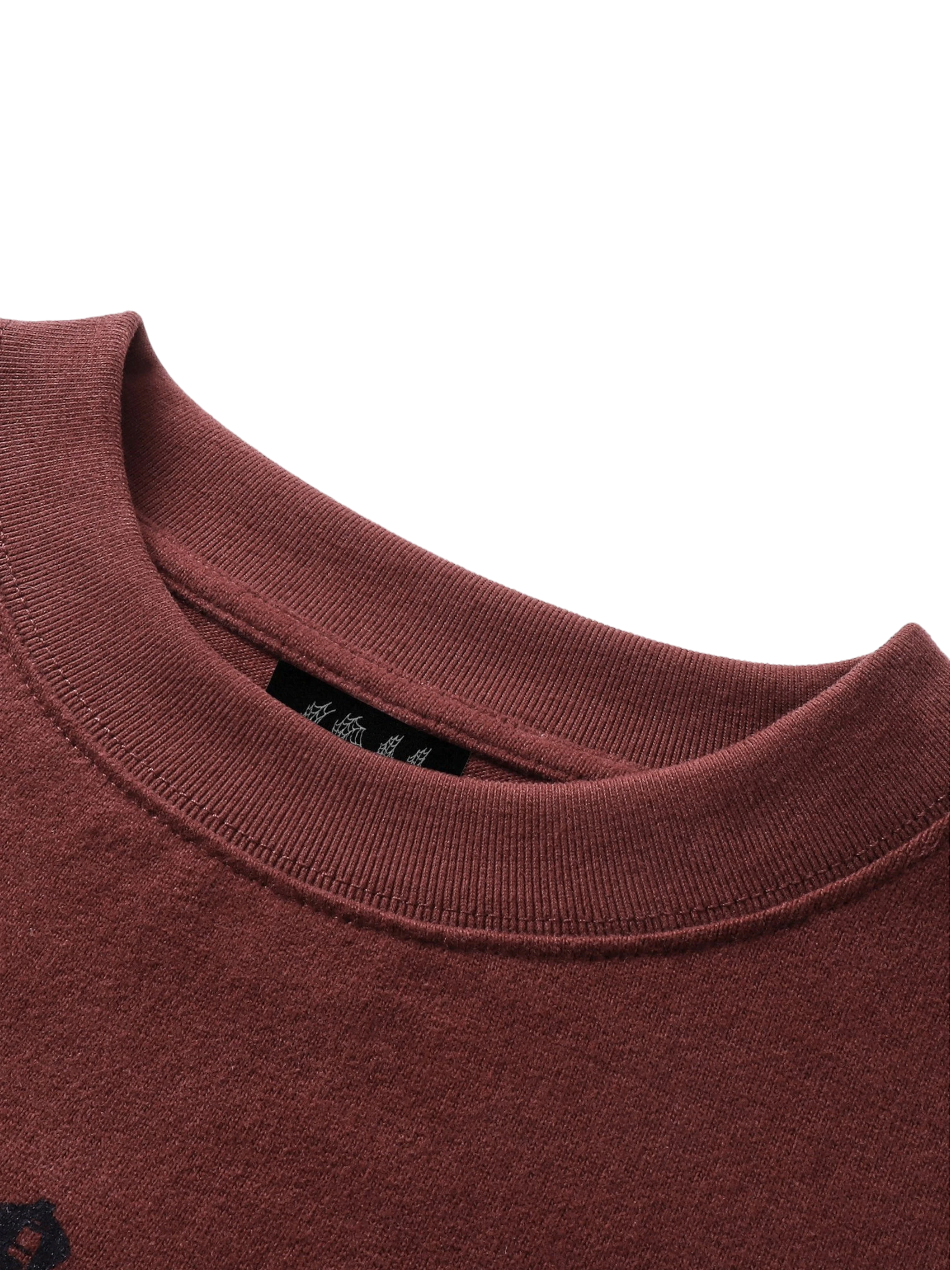 Close-up of the distressed knight print on TBHNP red tee — men's streetwear detail