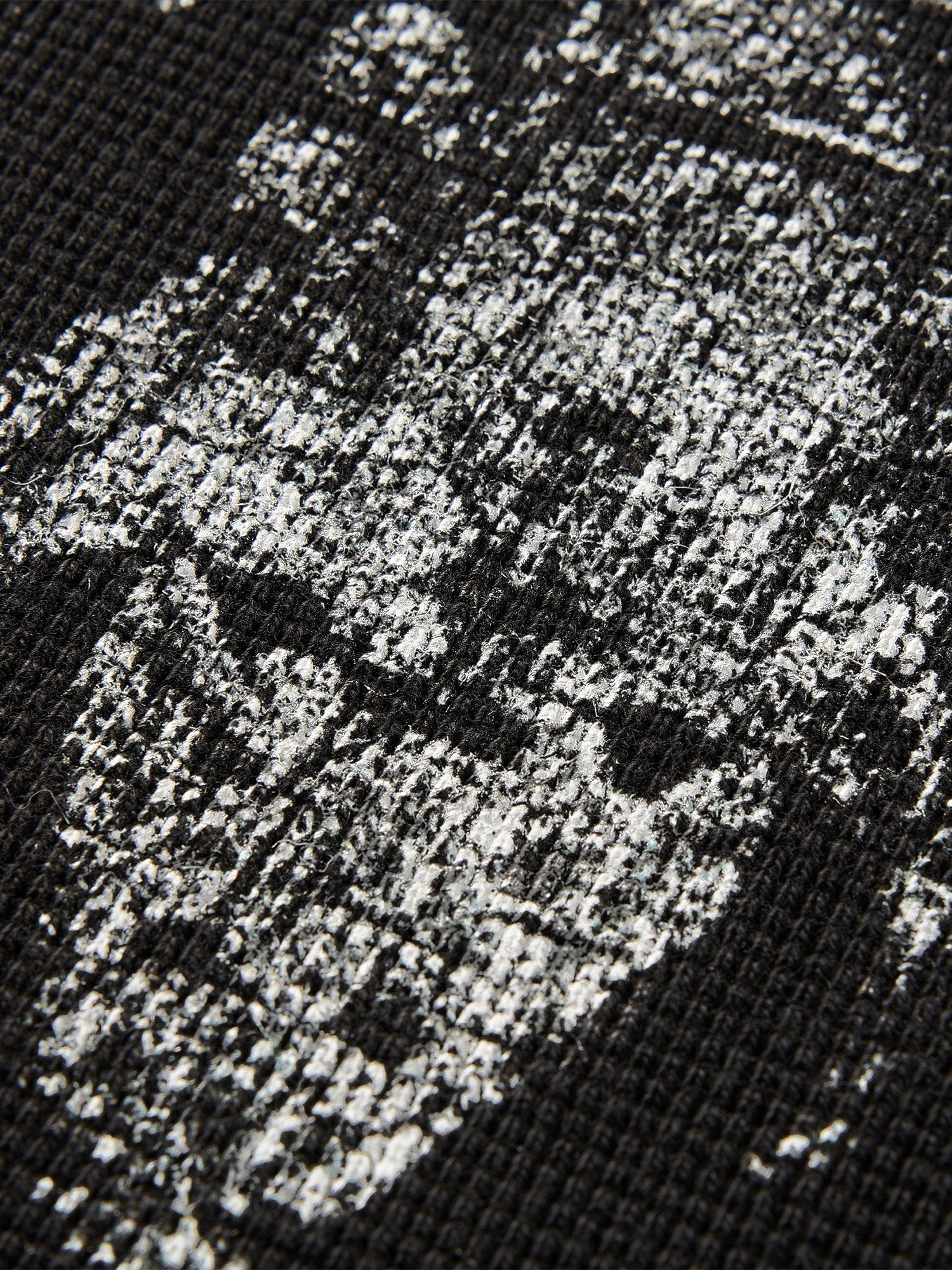 Close-up of the sword-and-bone print on TBHNP black waffle-knit tee — men's streetwear detail