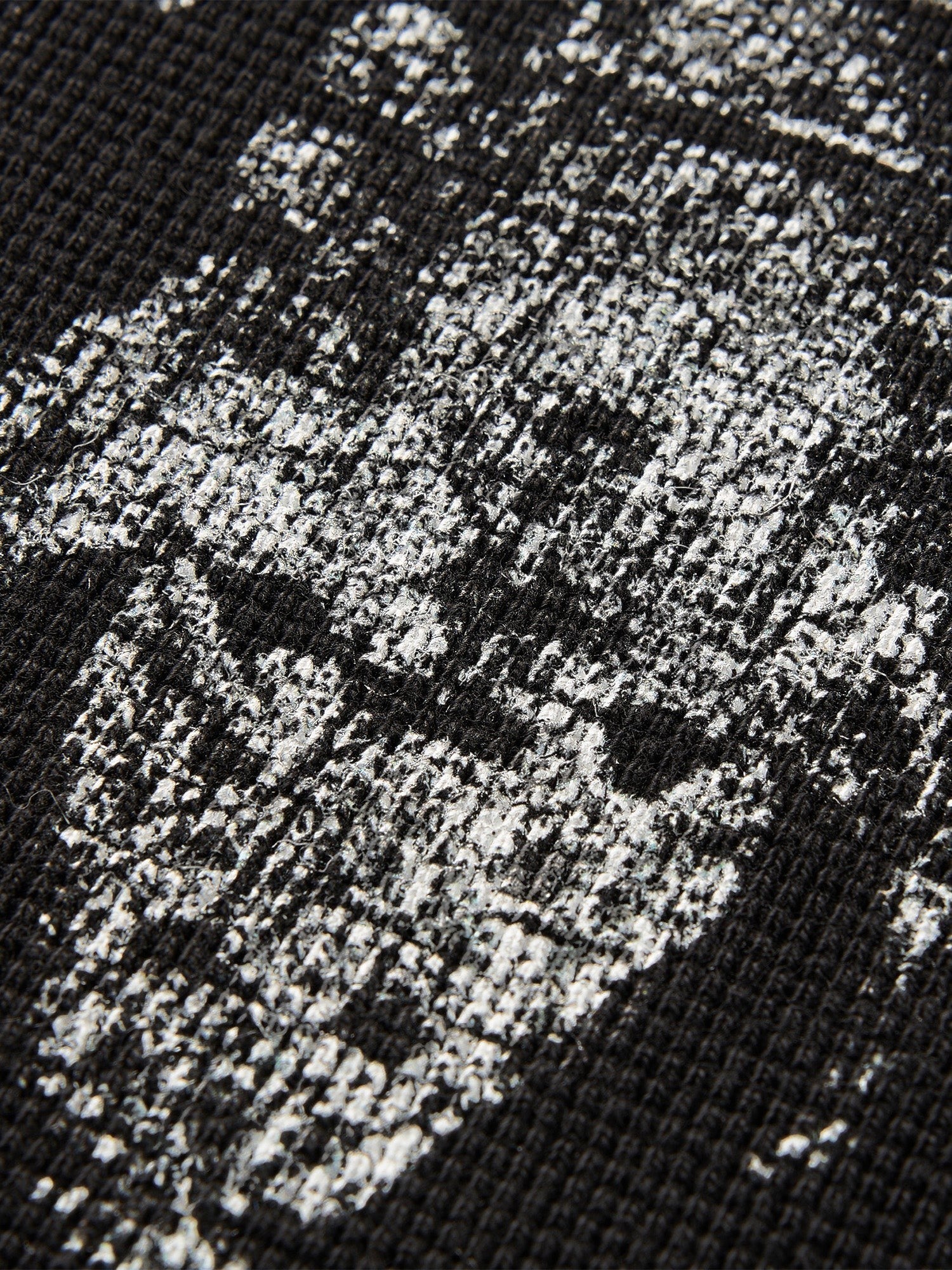Close-up of the sword-and-bone print on TBHNP black waffle-knit tee — men's streetwear detail