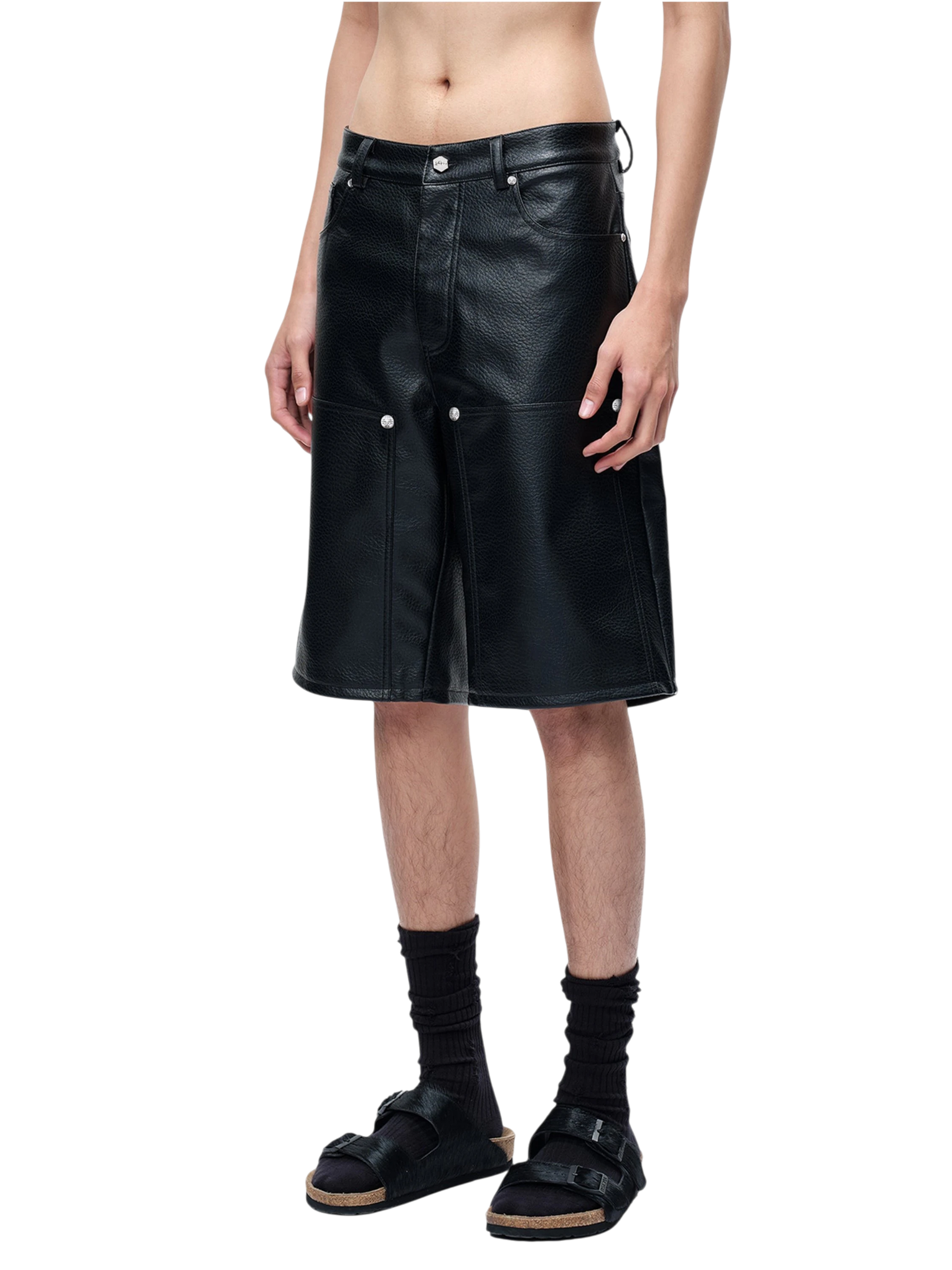 Model wearing TBHNP black faux-leather shorts, front — men's streetwear shorts