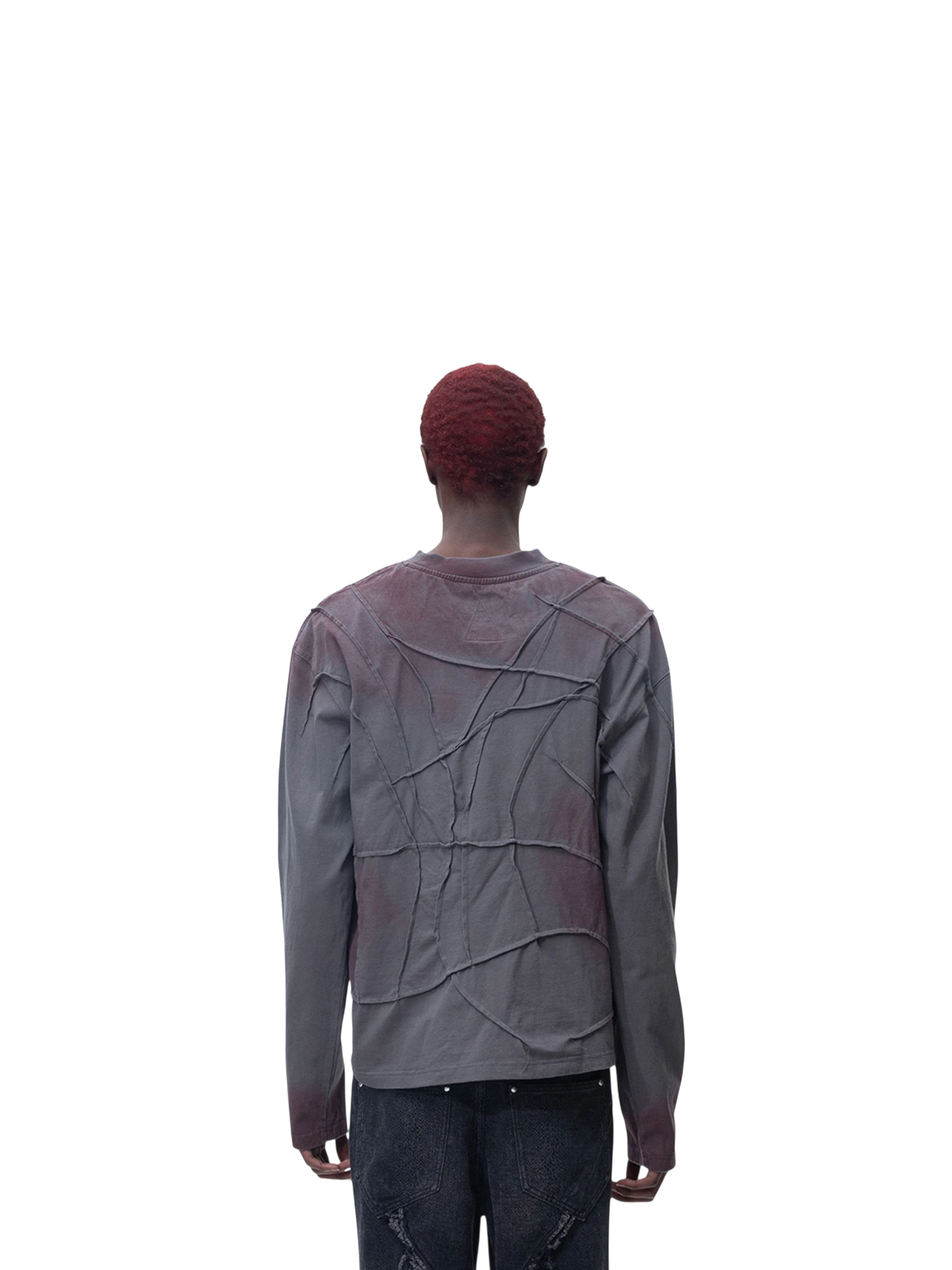 Model wearing TBHNP black sword-and-bone long-sleeve tee, back view — men's streetwear tee
