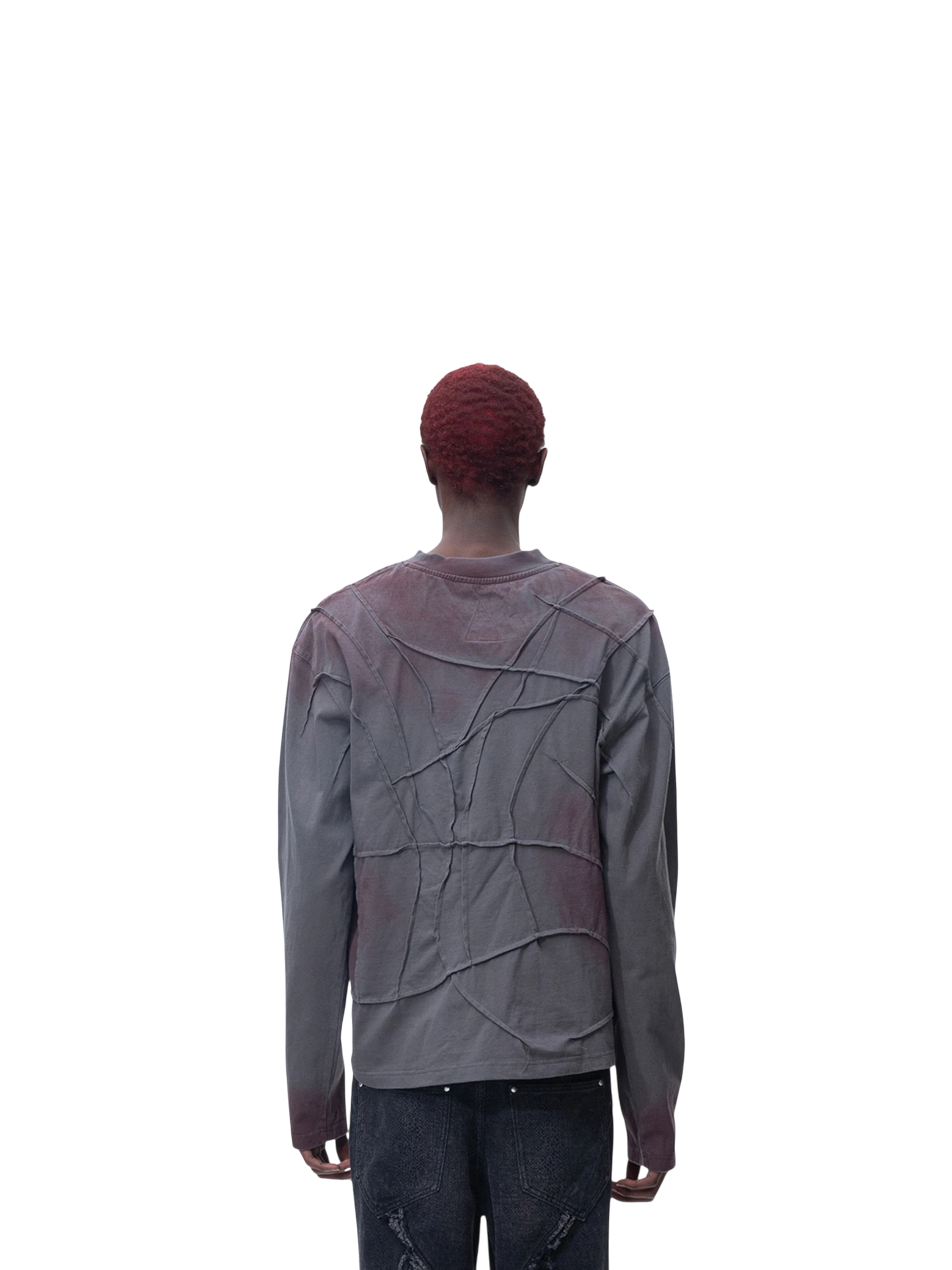 Model wearing TBHNP black sword-and-bone long-sleeve tee, back view — men's streetwear tee