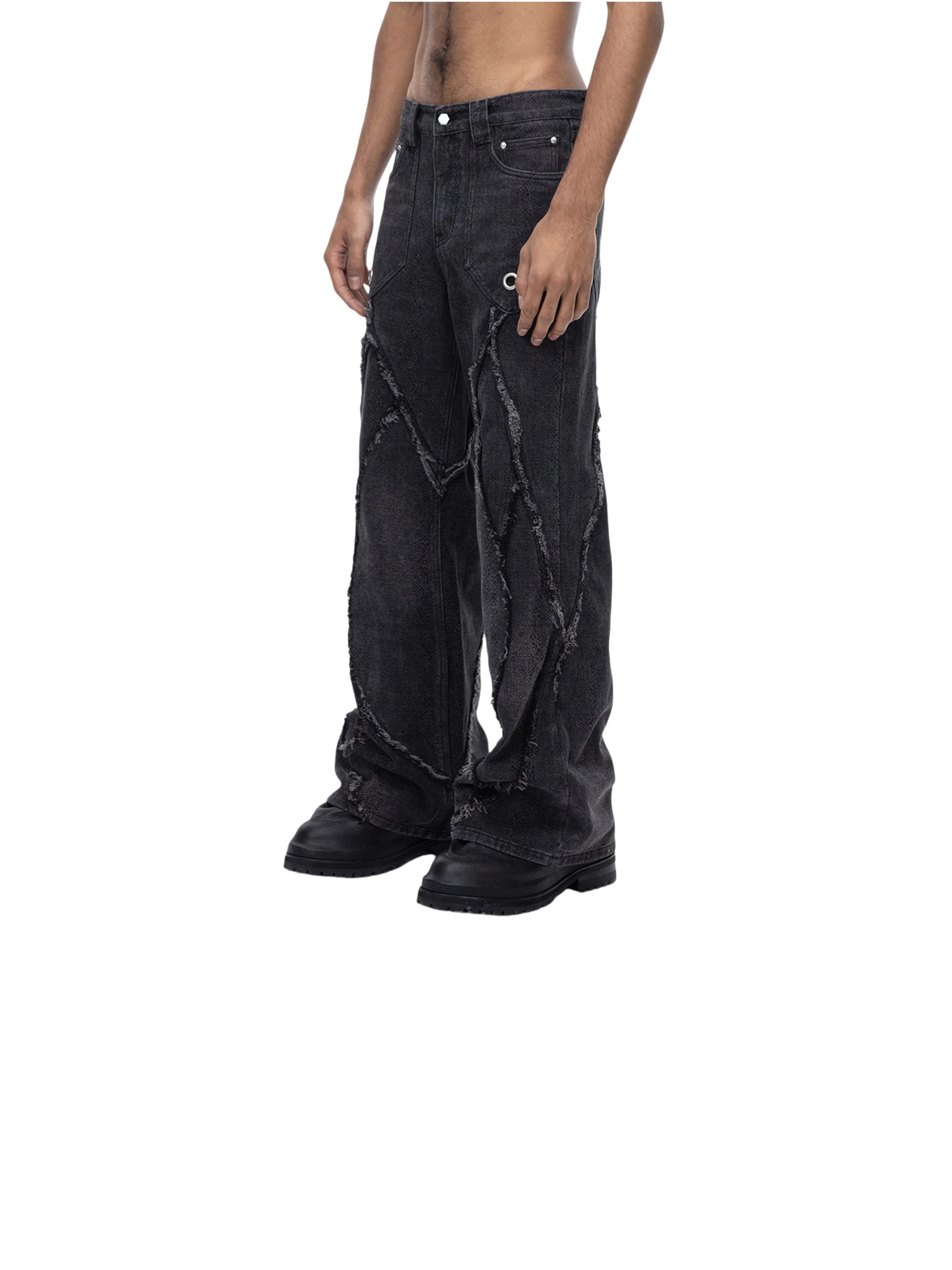 Model wearing TBHNP black cobra print baggy jeans, front lower-body — men's streetwear denim
