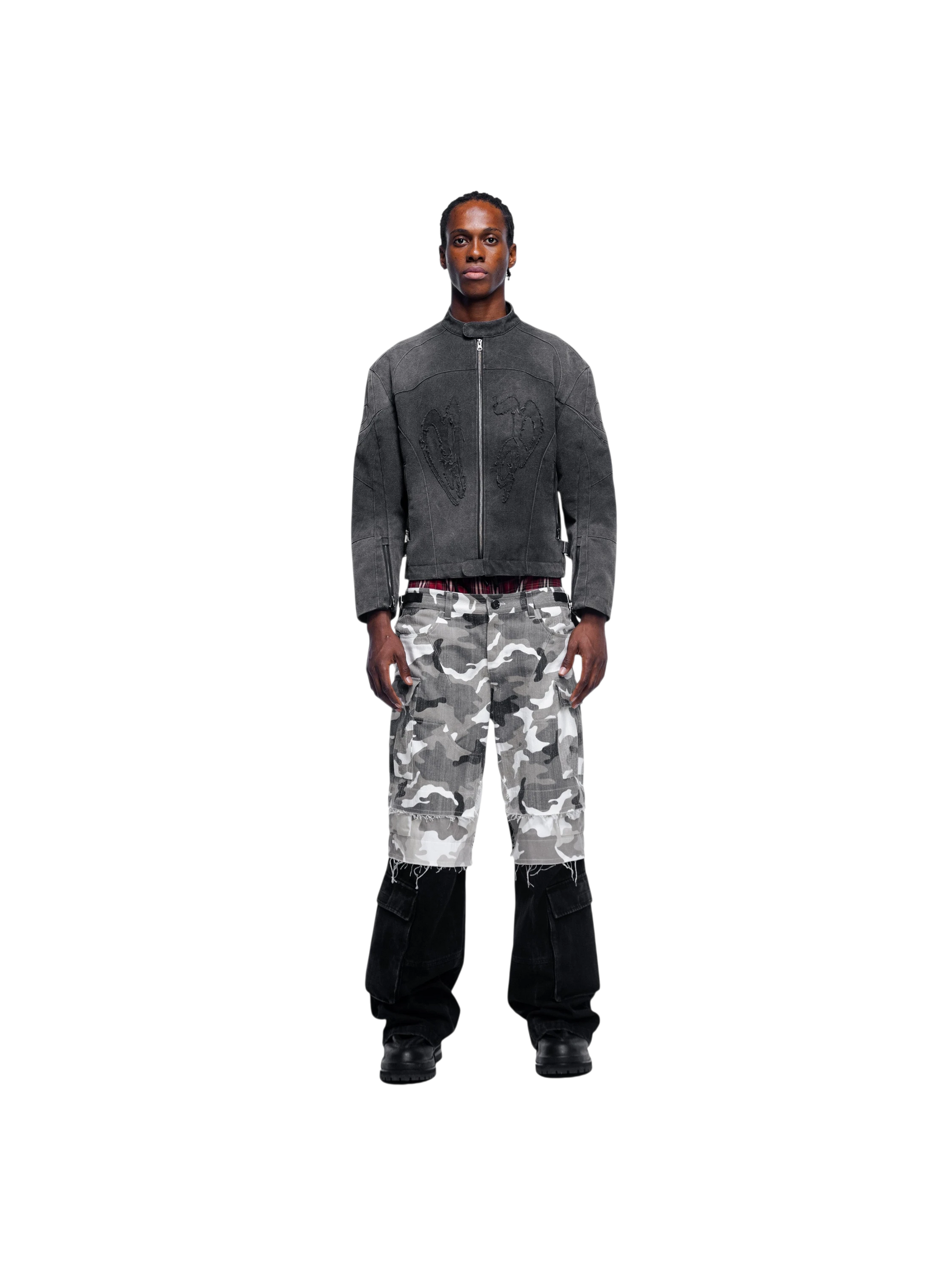 Model in TBHNP black canvas moto jacket with camo pants, full-length front — men's streetwear