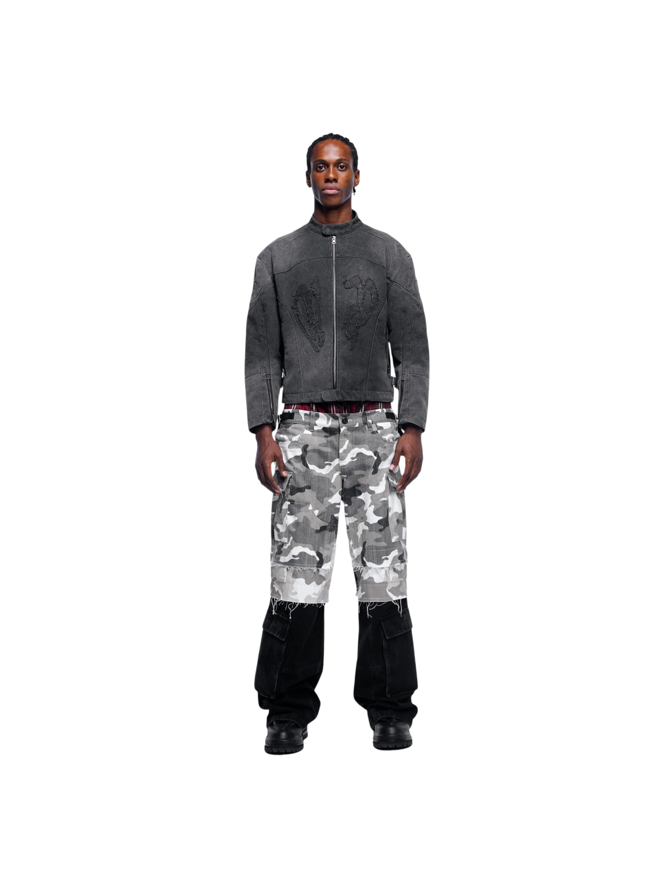 Model in TBHNP black canvas moto jacket with camo pants, full-length front — men's streetwear