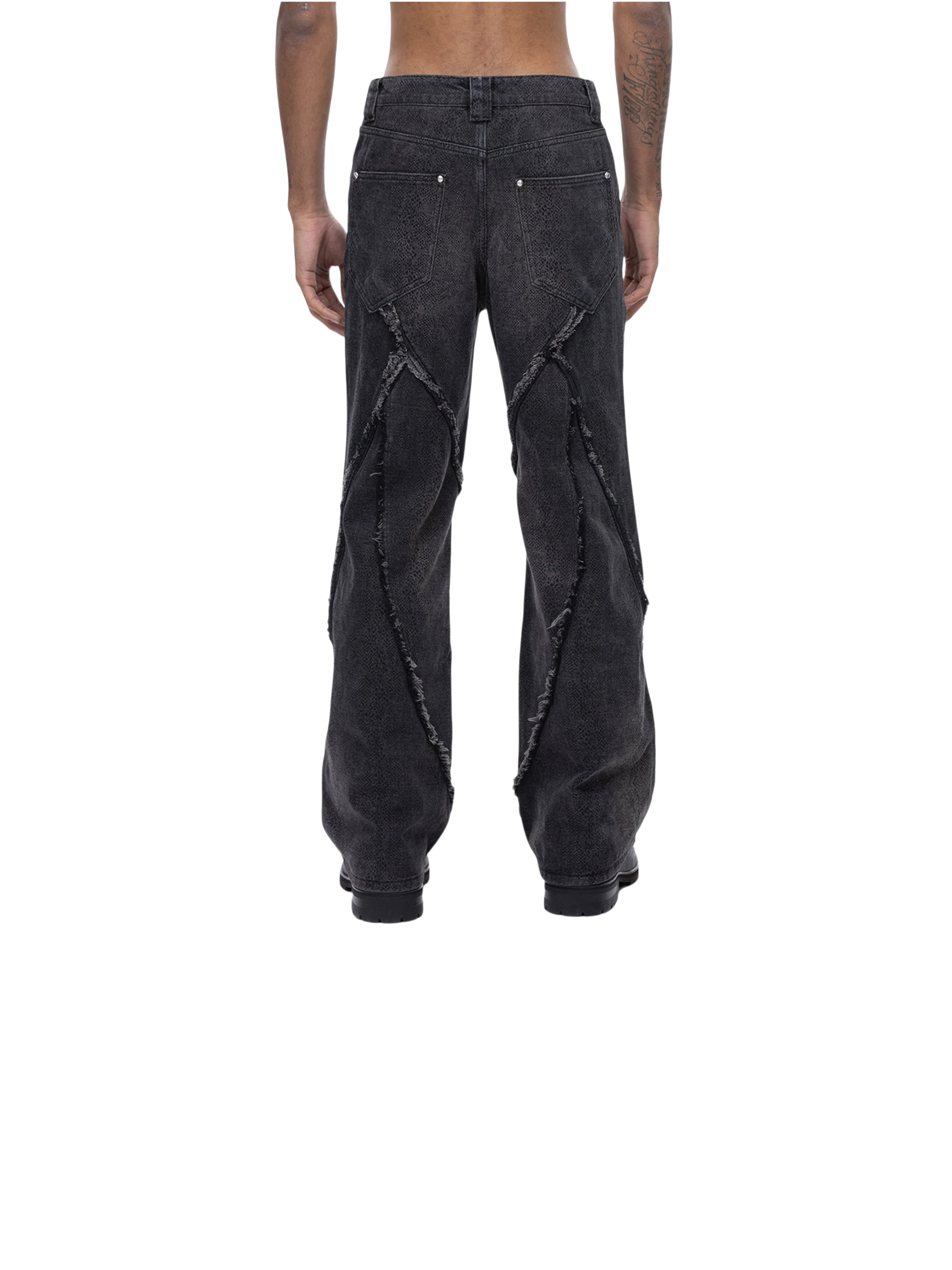 Model in TBHNP cobra print baggy jeans, front detail — men's streetwear denim