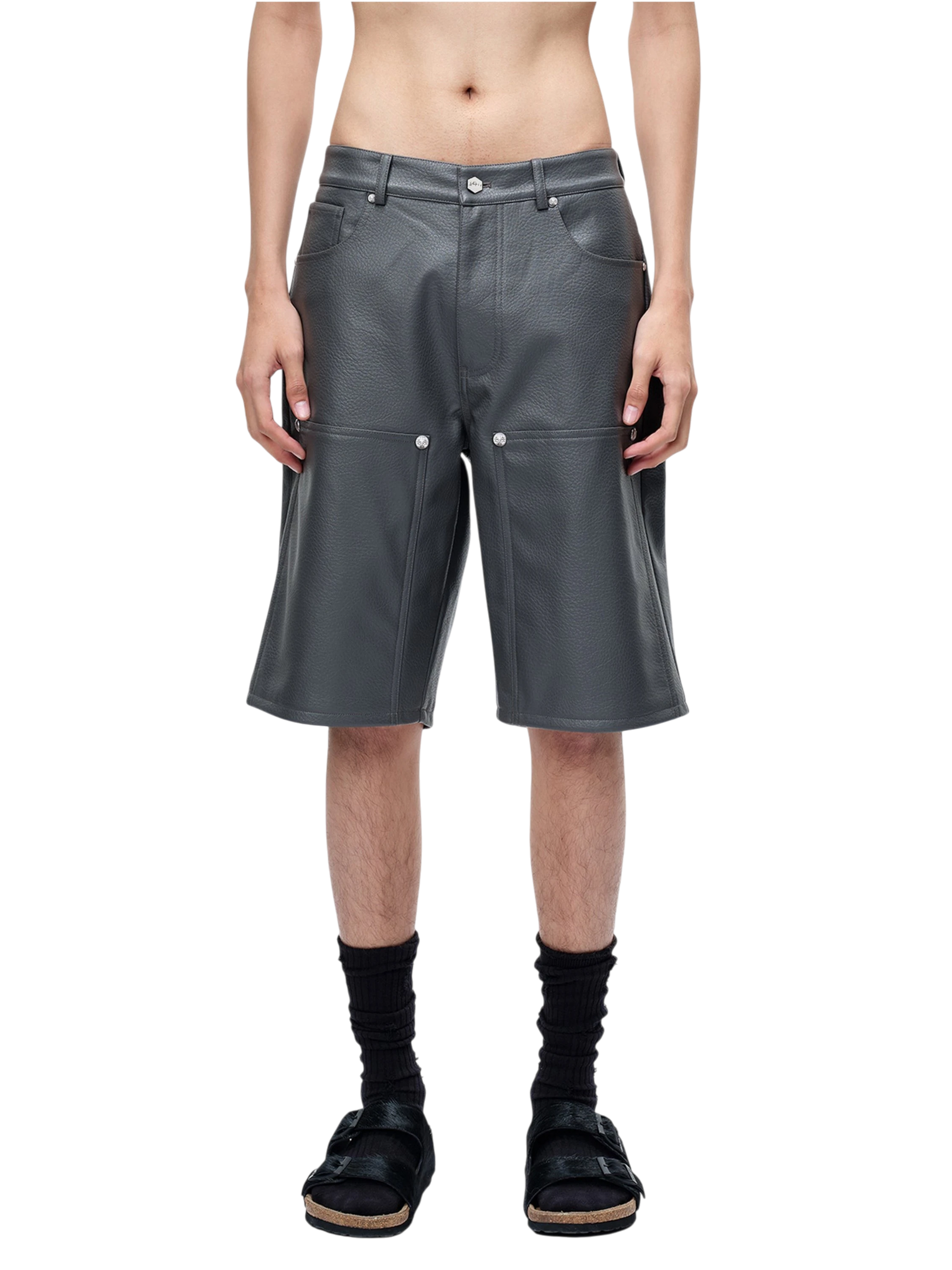 Model styling TBHNP grey faux-leather shorts, front detail — men's streetwear shorts