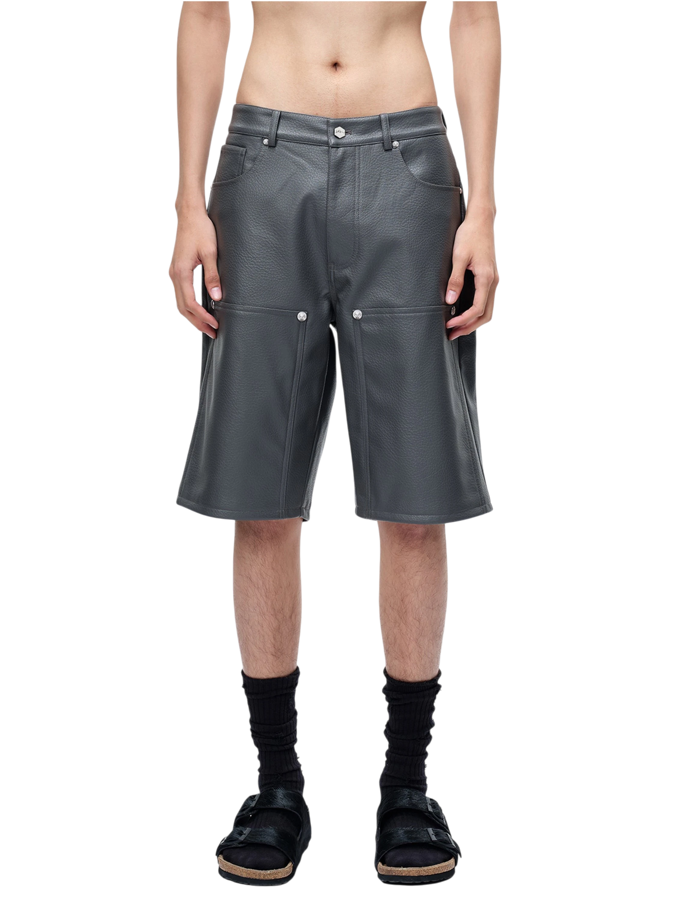 Model styling TBHNP grey faux-leather shorts, front detail — men's streetwear shorts