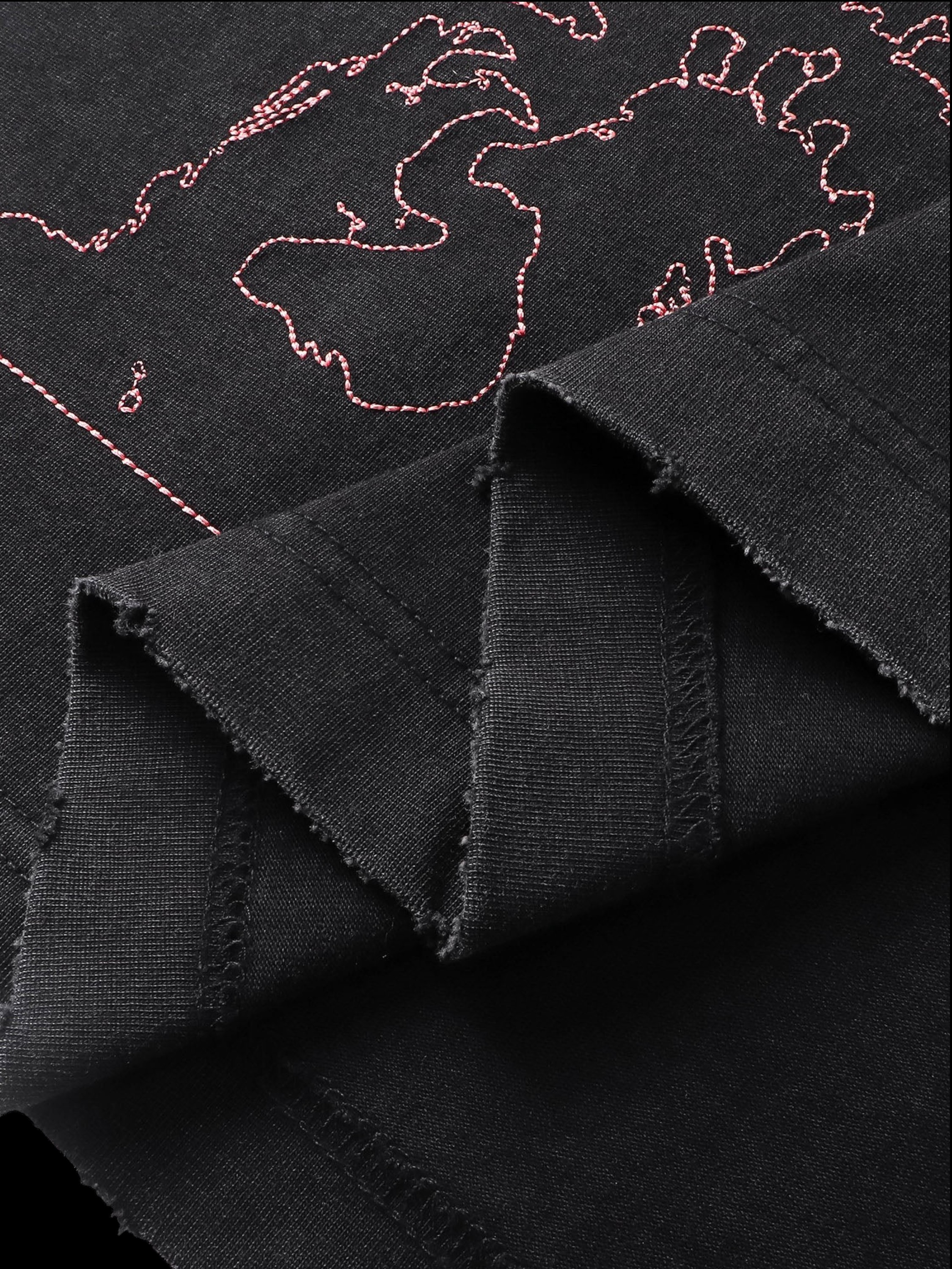 Close-up of the back graphic print on TBHNP black arrival short-sleeve tee — men's streetwear detail
