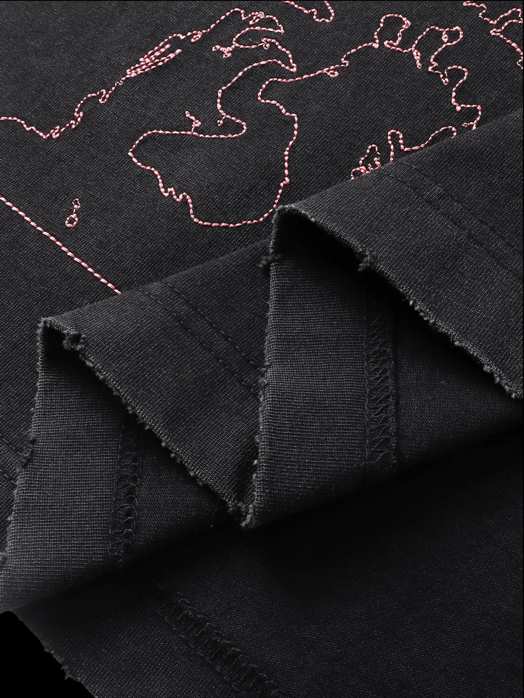 Close-up of the back graphic print on TBHNP black arrival short-sleeve tee — men's streetwear detail