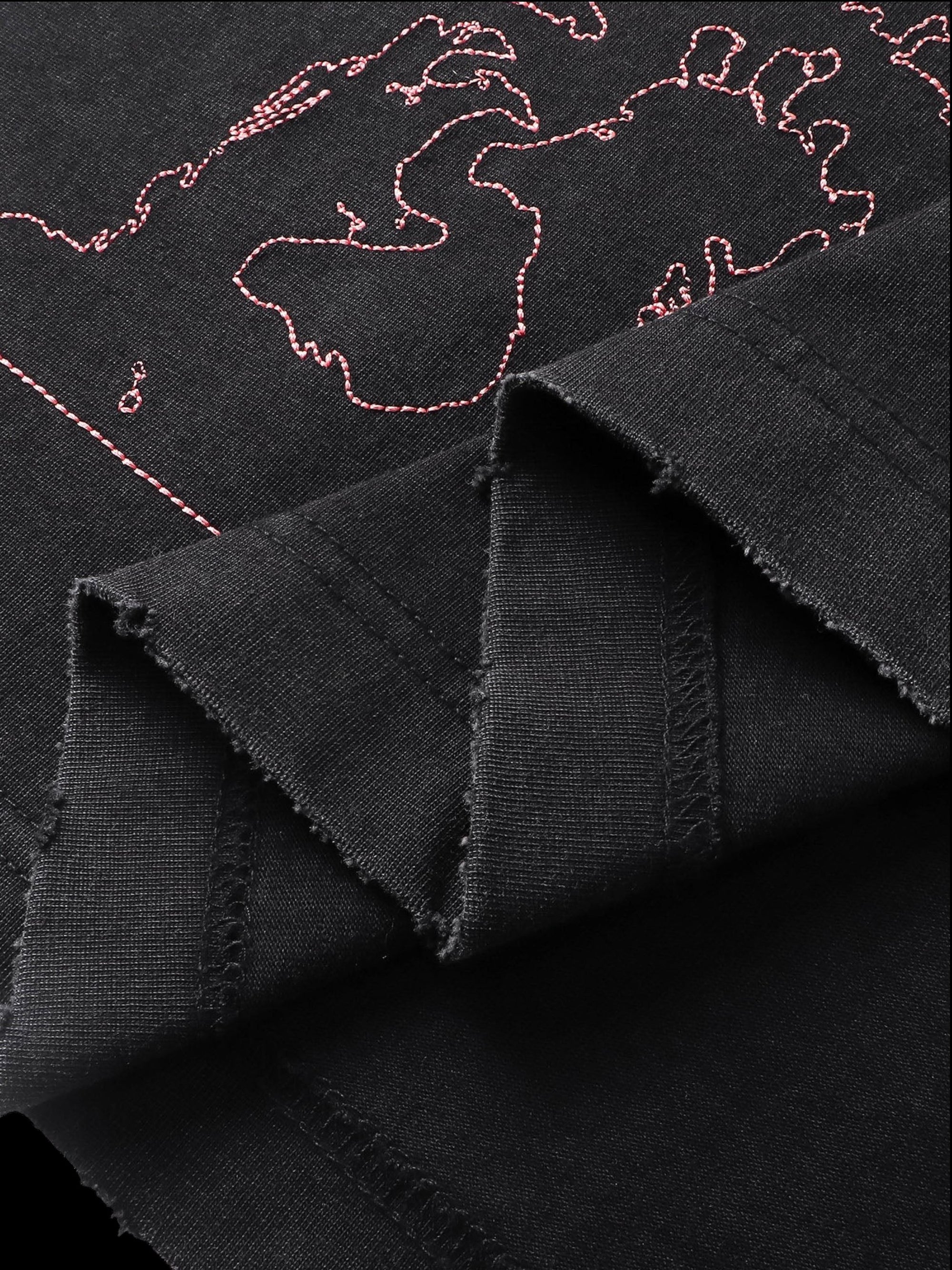 Close-up of the back graphic print on TBHNP black arrival short-sleeve tee — men's streetwear detail