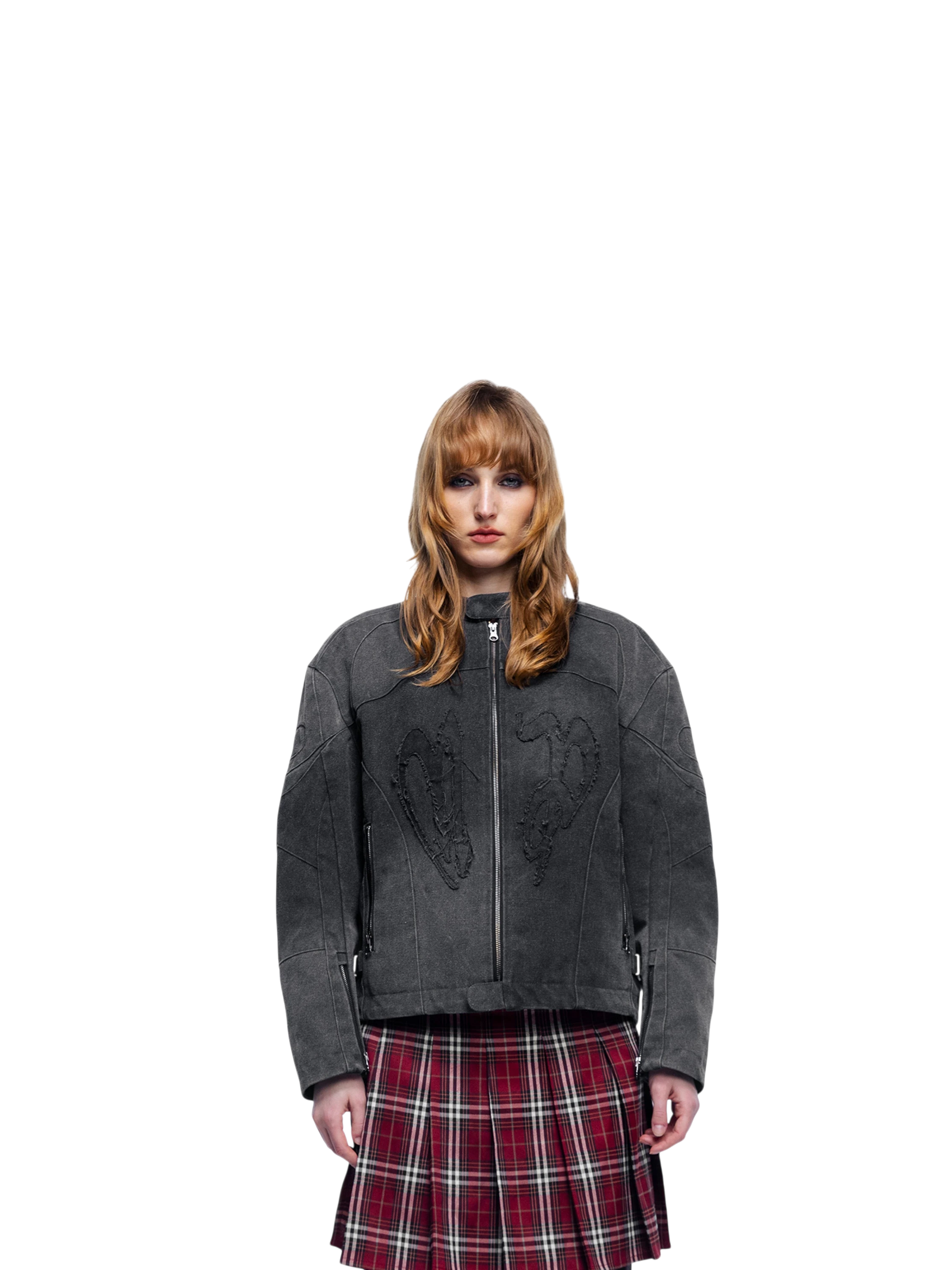 Female model wearing TBHNP black canvas moto jacket, front — men's streetwear jacket