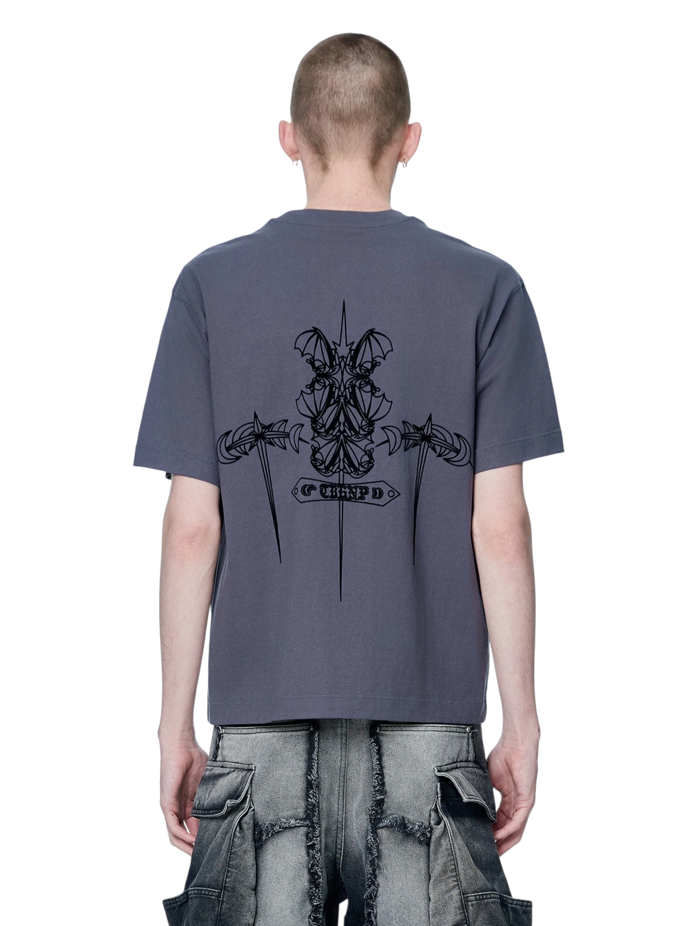 Model wearing TBHNP dark grey Emblem & Shadowbat tee, back view — men's streetwear tee