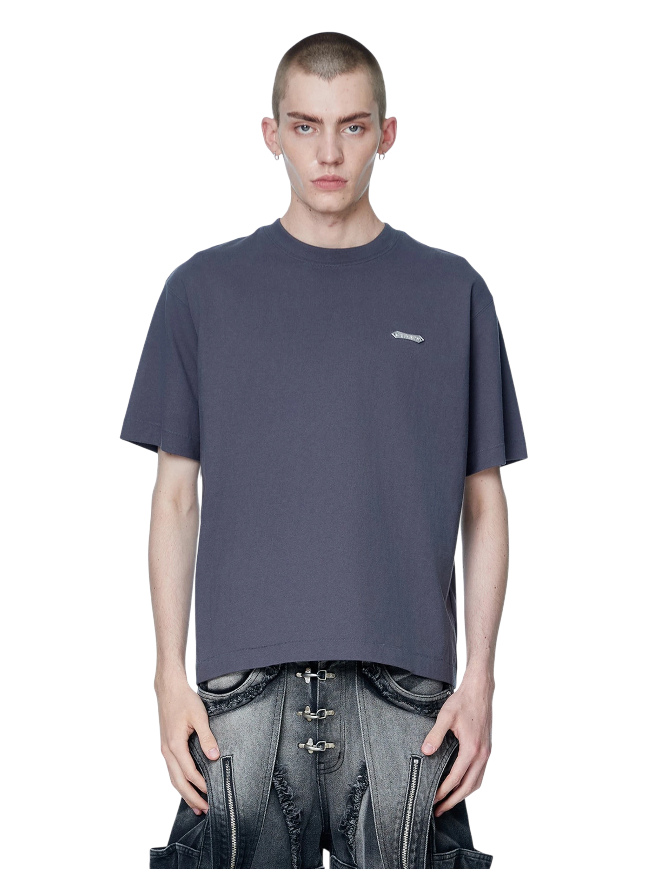 Model wearing TBHNP dark grey Emblem & Shadowbat tee, front — men's streetwear tee