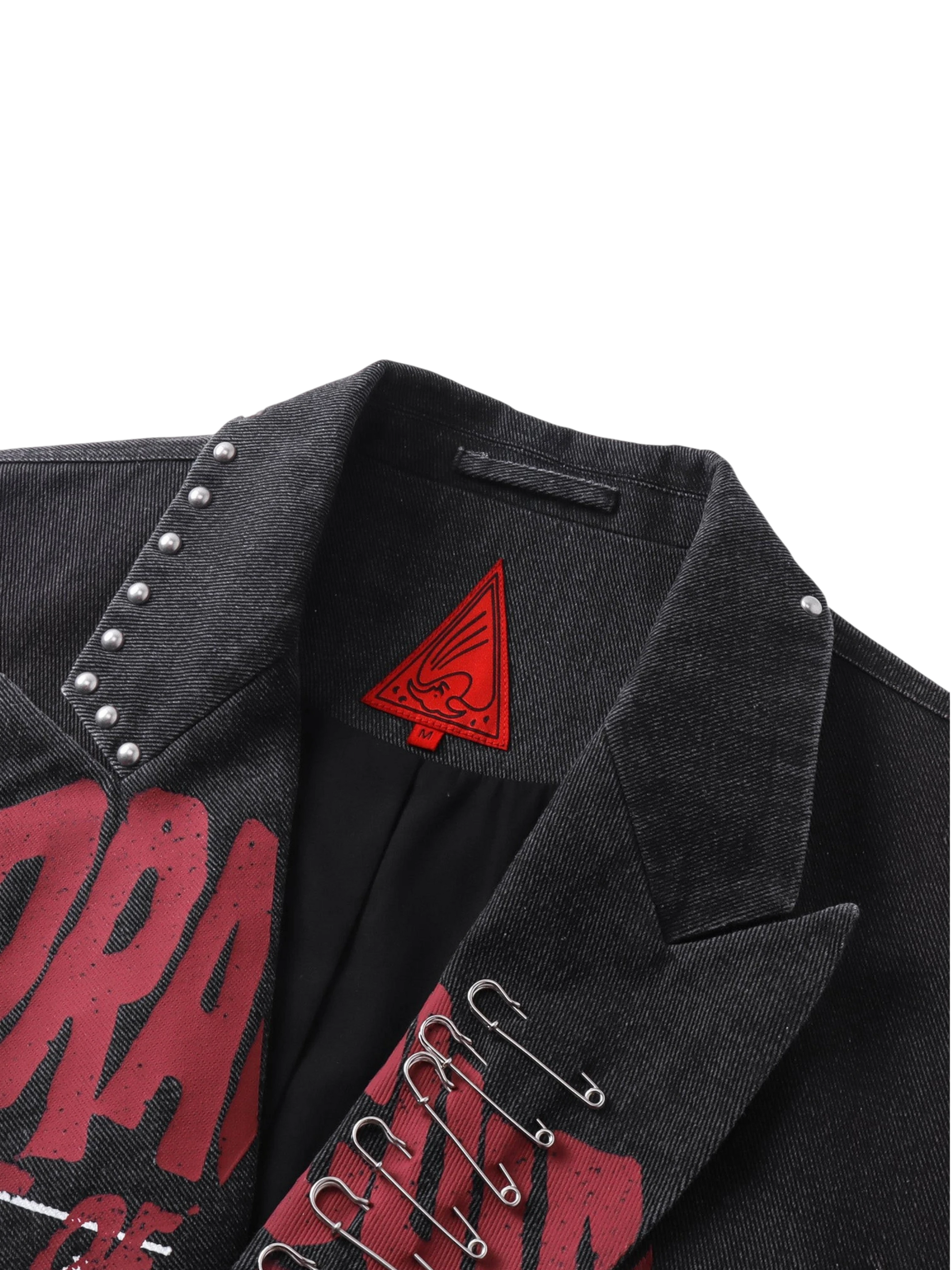 Close-up of the studded shoulder and graphic print on TBHNP black blazer — men's streetwear detail
