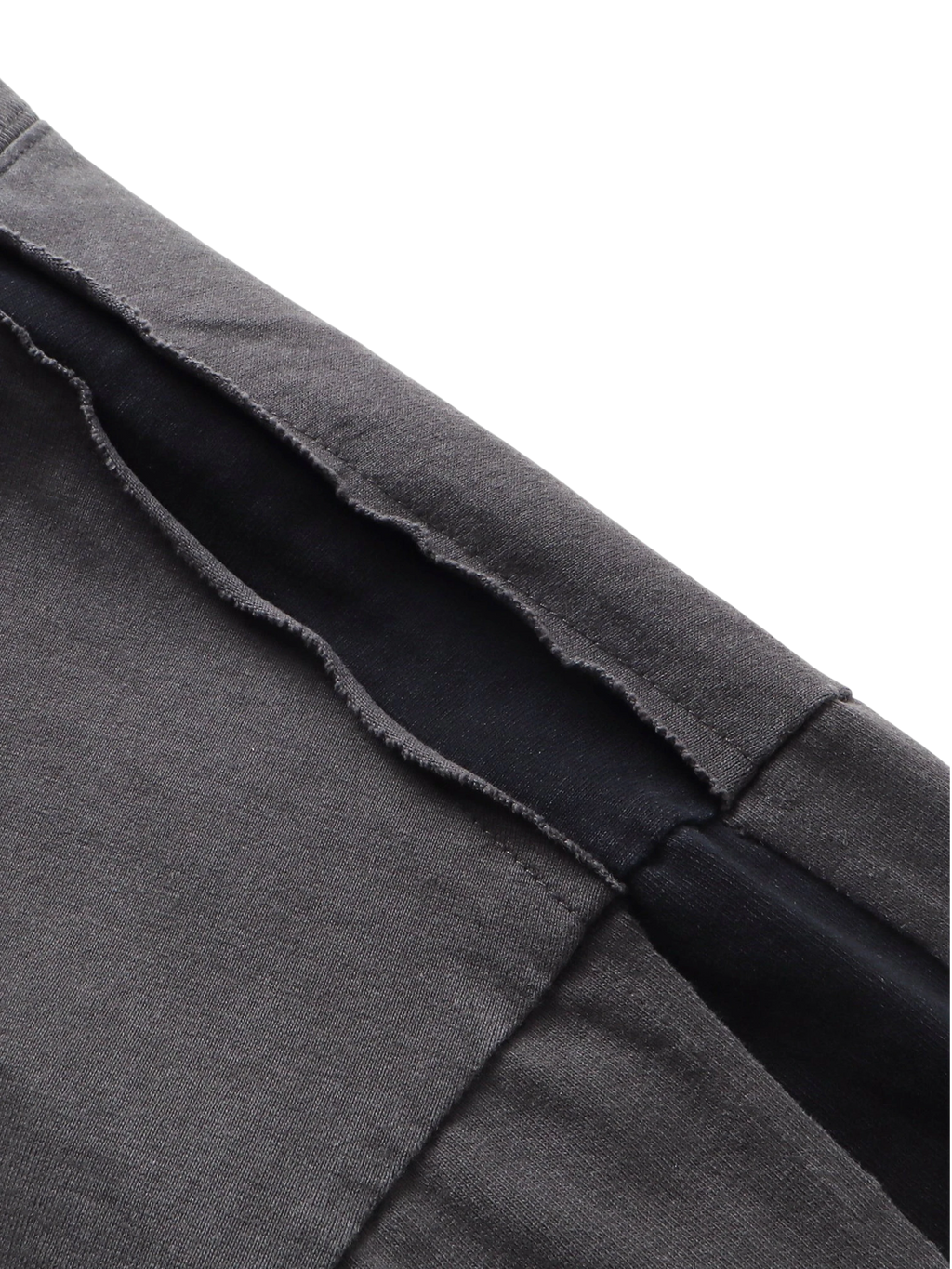 Close-up of the distressed double-wash finish on TBHNP black knight tee — men's streetwear detail
