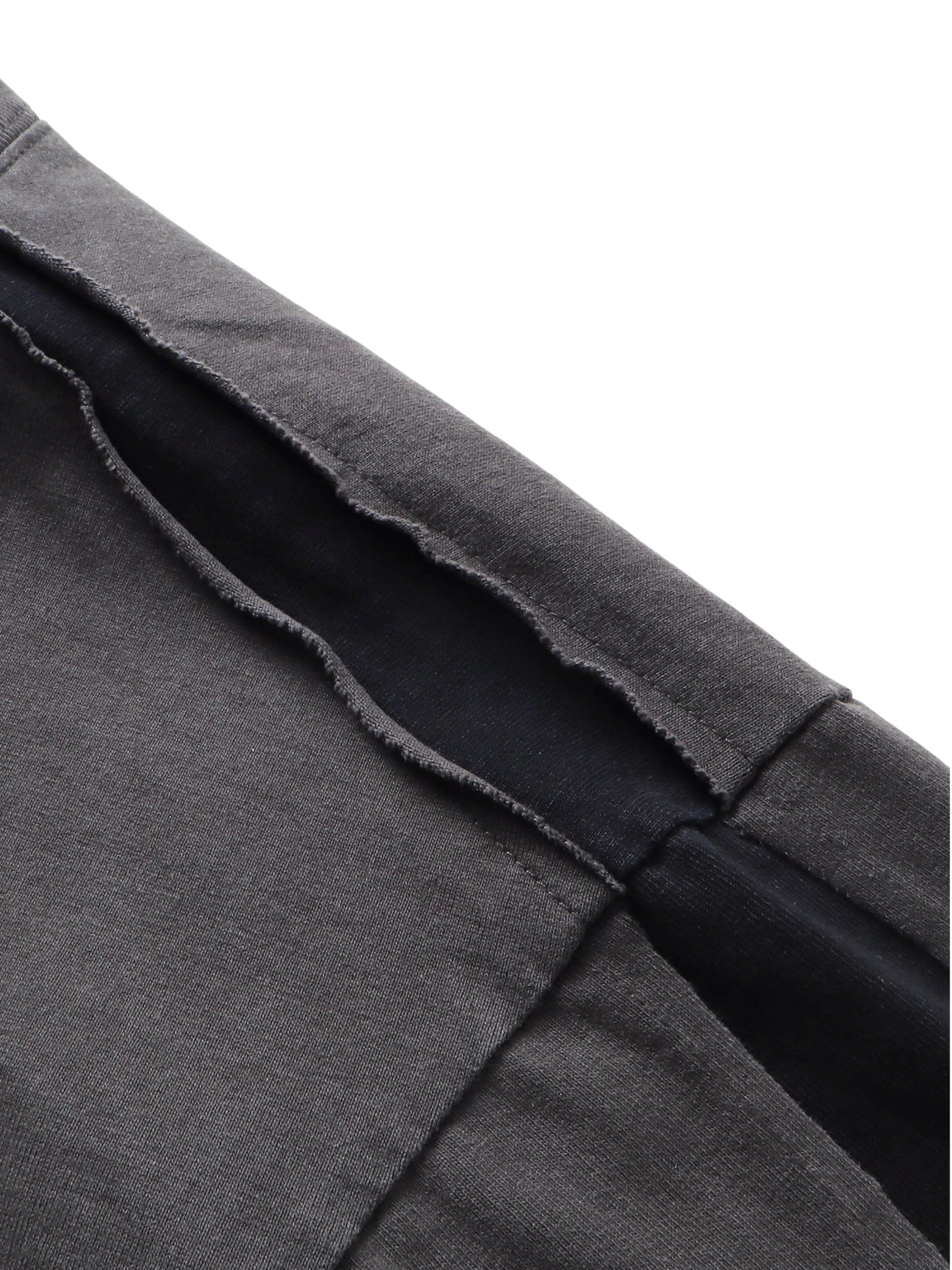 Close-up of the distressed double-wash finish on TBHNP black knight tee — men's streetwear detail