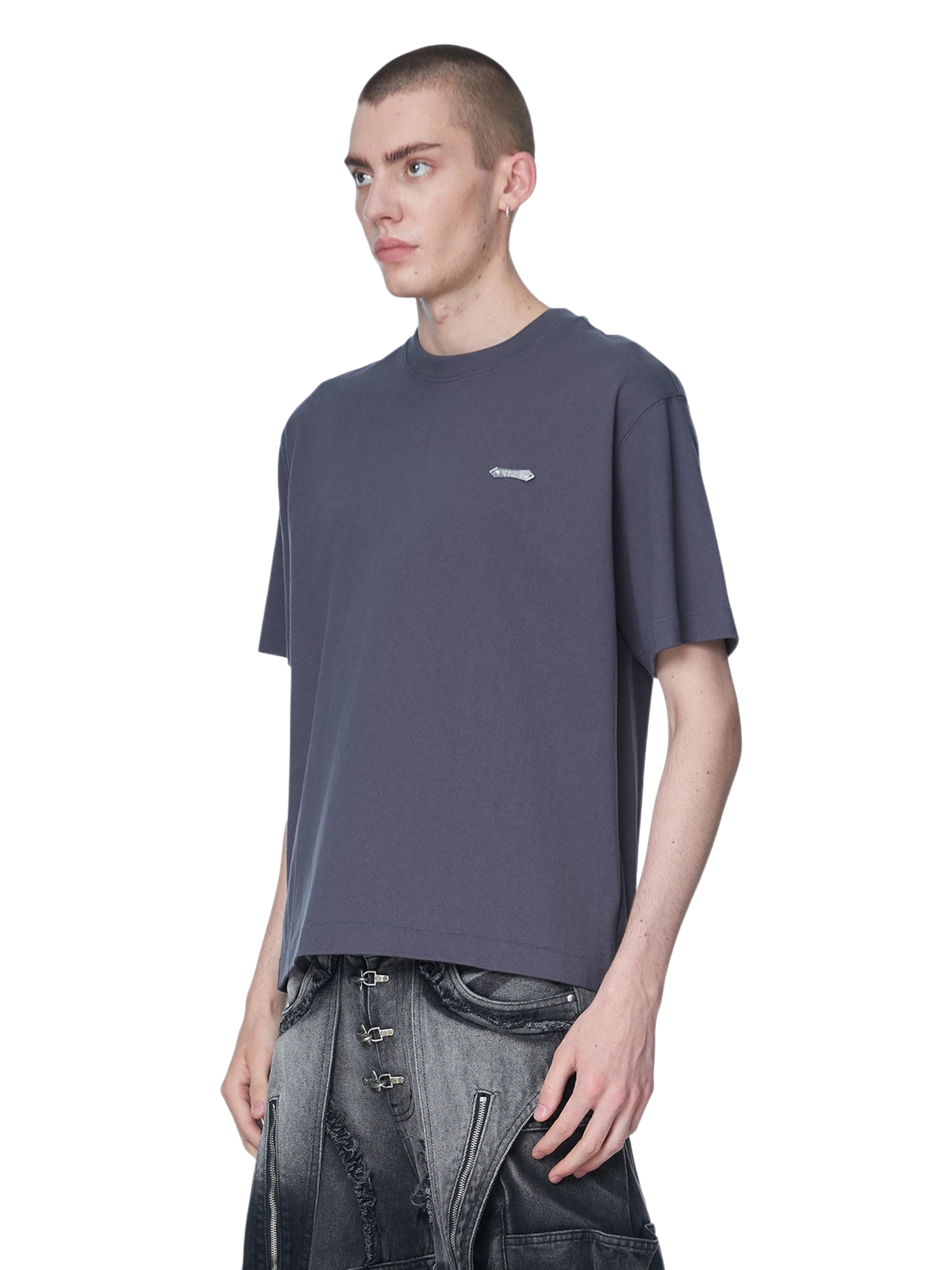 Model styling TBHNP dark grey Emblem & Shadowbat tee, front detail — men's streetwear tee