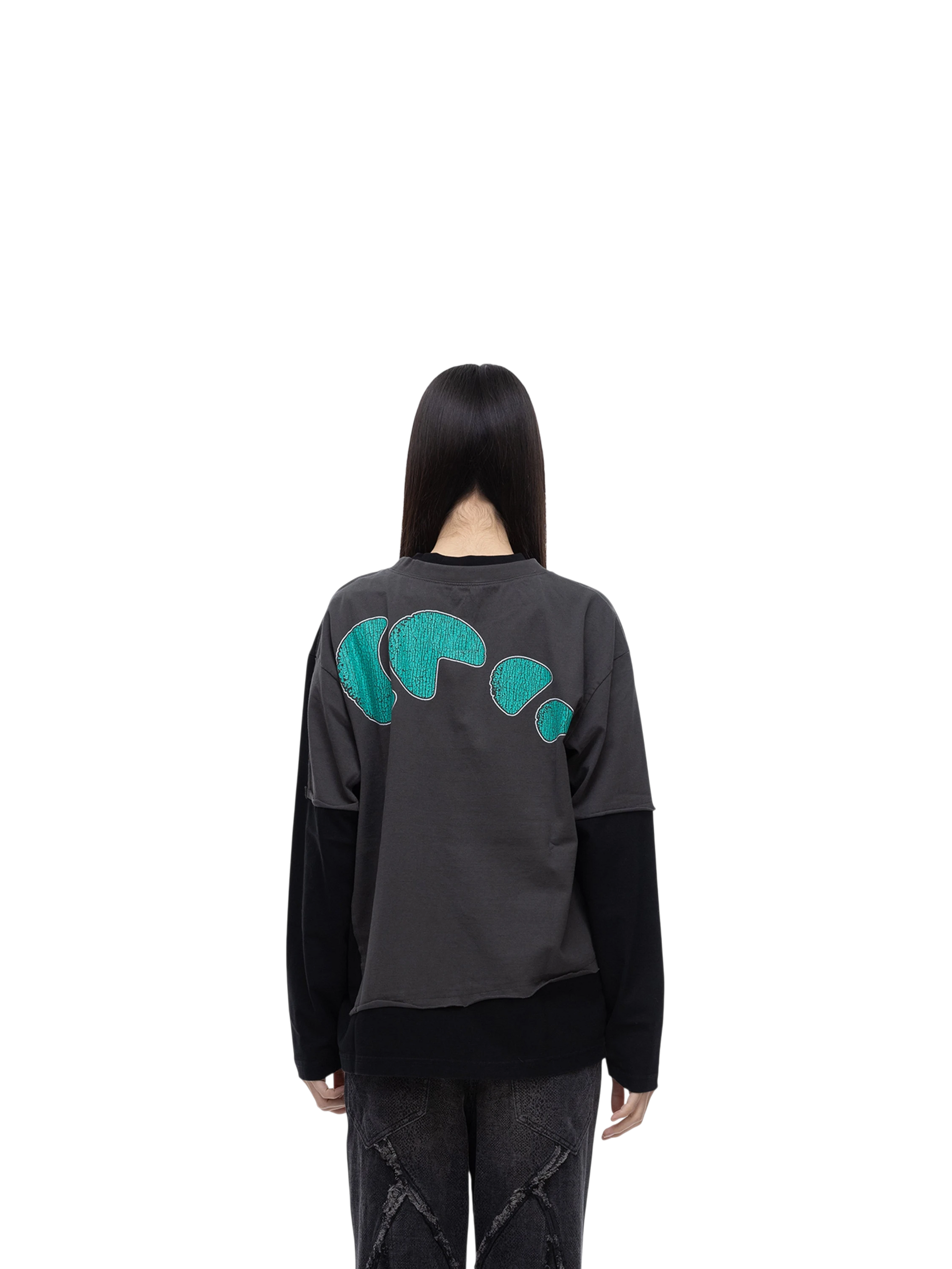 Model wearing TBHNP black arrival knight long-sleeve tee, back view — men's streetwear tee