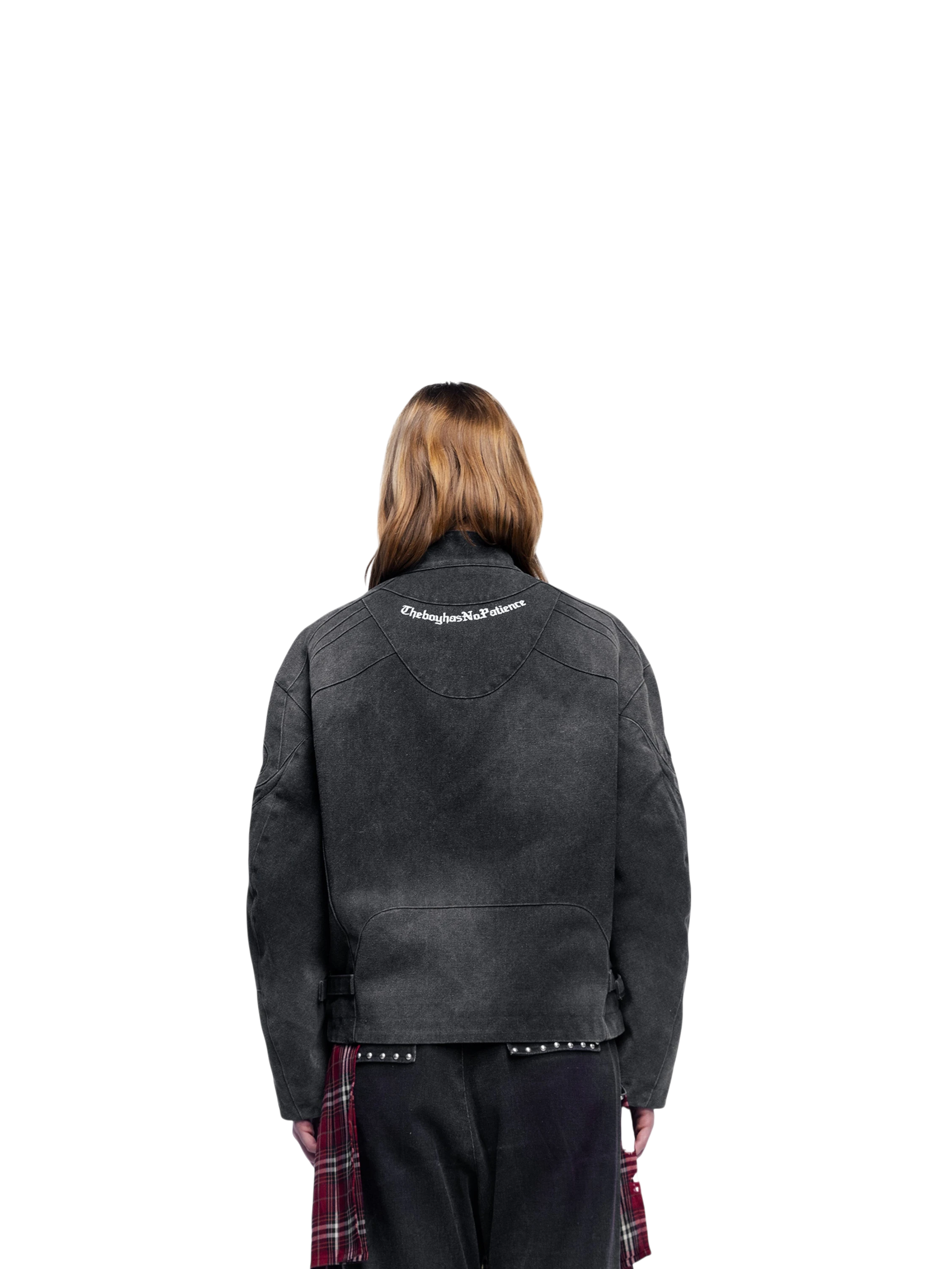 Female model wearing TBHNP black canvas moto jacket, back view — men's streetwear jacket